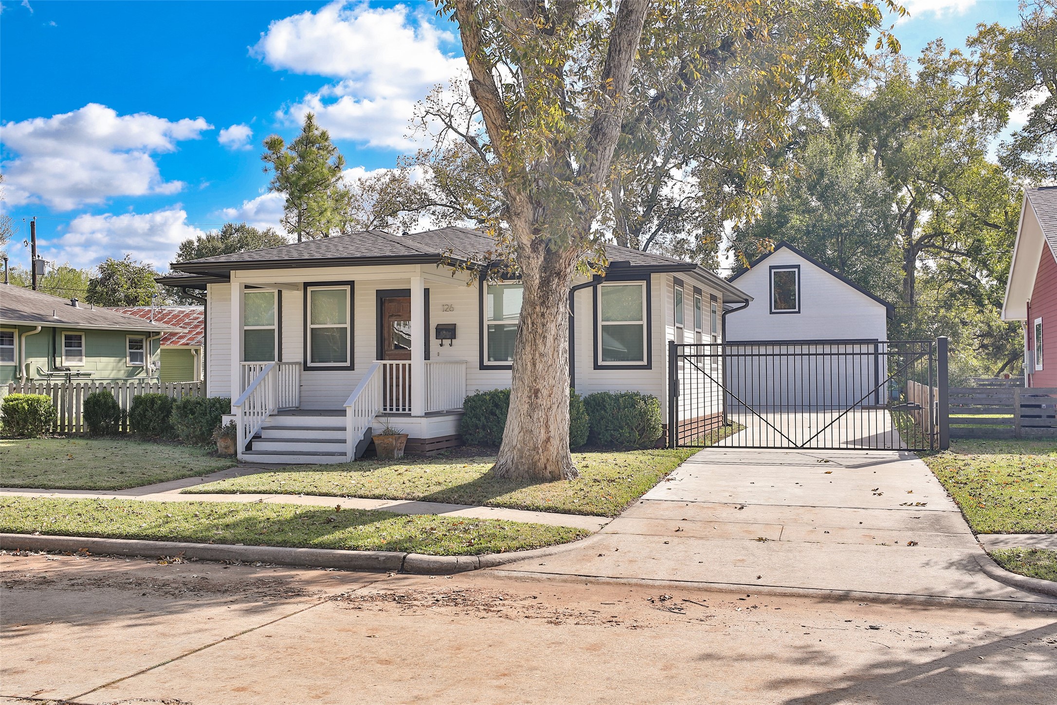 126 2nd Street Sugar Land, TX 77498 - Photo 5 of 50 a front view of a house with a yard and garage