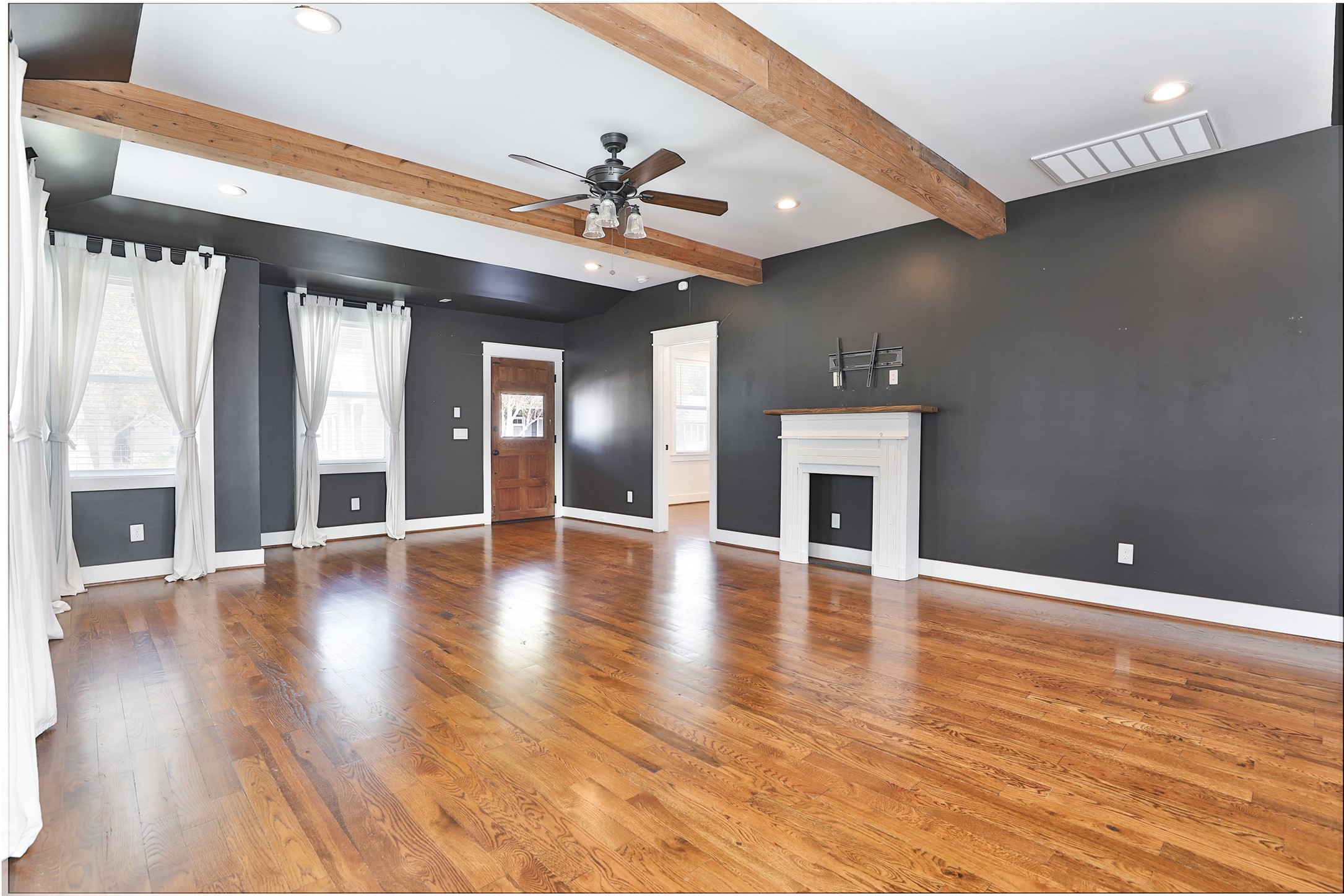 126 2nd Street Sugar Land, TX 77498 - Photo 10 of 50 a view of an empty room with window and wooden floor