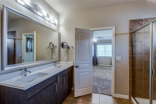 a bathroom with a double vanity sink and a mirror