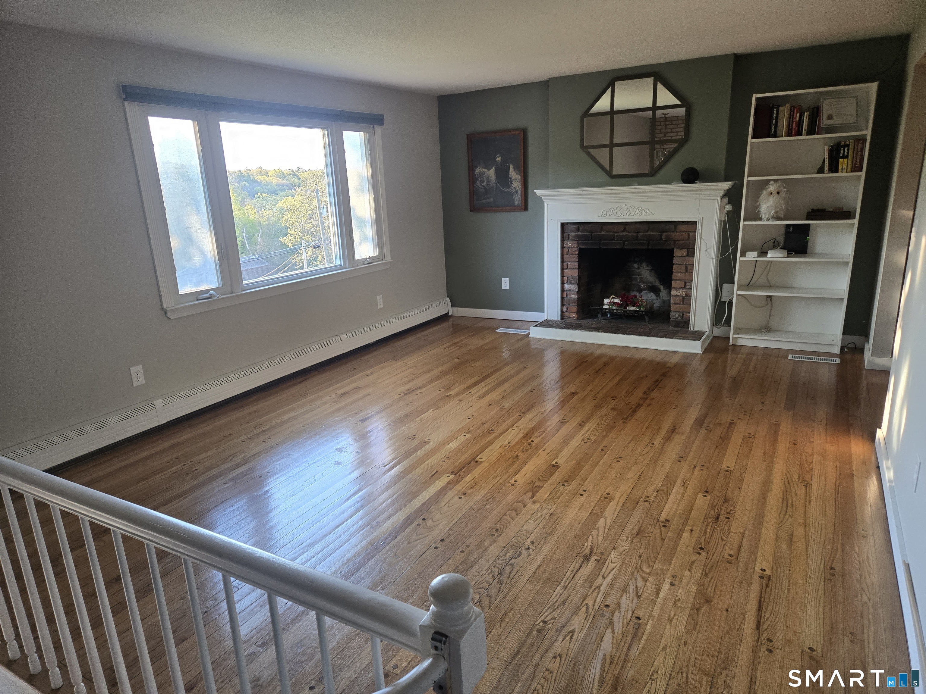 1004 Hickory Hill Road Thomaston, CT 06787 - Photo 12 of 23 a living room with wooden floor and a fireplace