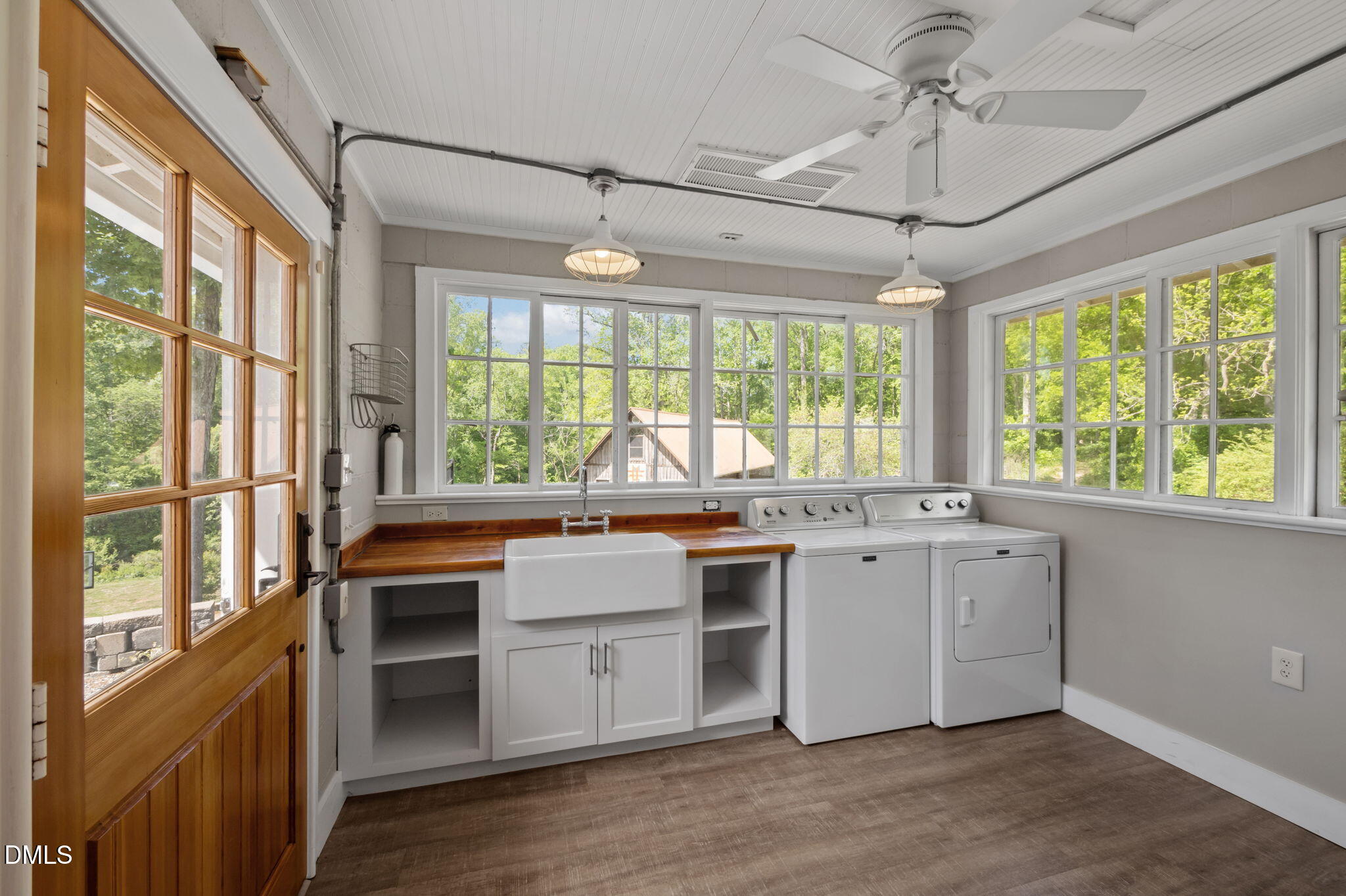 7923 Morrow Mill Road Chapel Hill, NC 27516 - Photo 46 of 66 a large kitchen with kitchen island a large window a sink and stainless steel appliances
