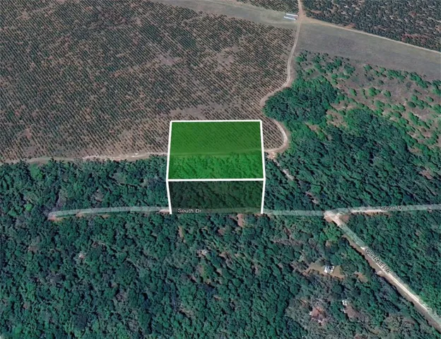 an aerial view of residential house with outdoor space and street view