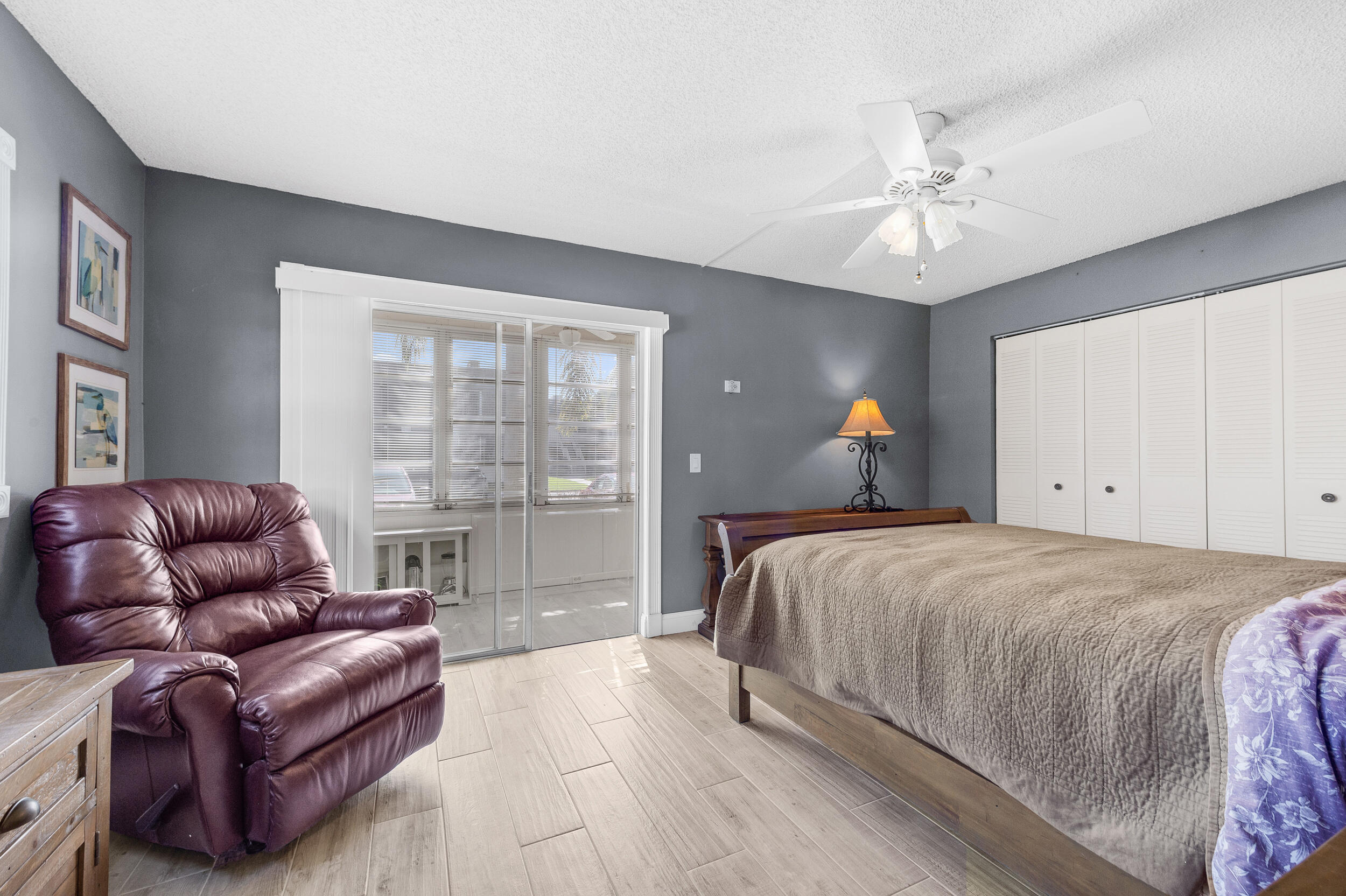 488 Burgundy P Delray Beach, FL 33484 - Photo 12 of 33 a spacious bedroom with a bed couch and window