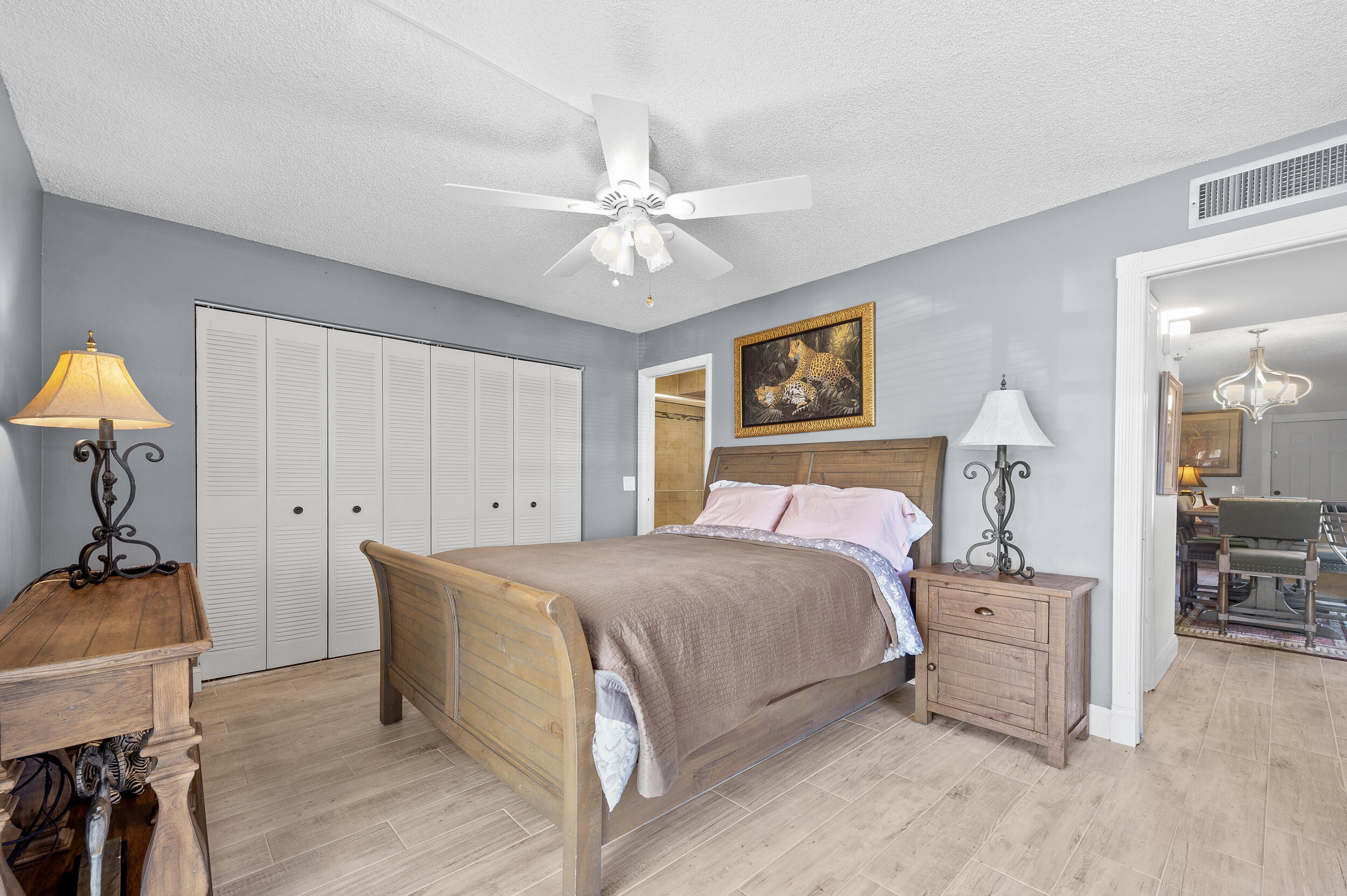 488 Burgundy P Delray Beach, FL 33484 - Photo 13 of 33 a bedroom with a bed and a chandelier