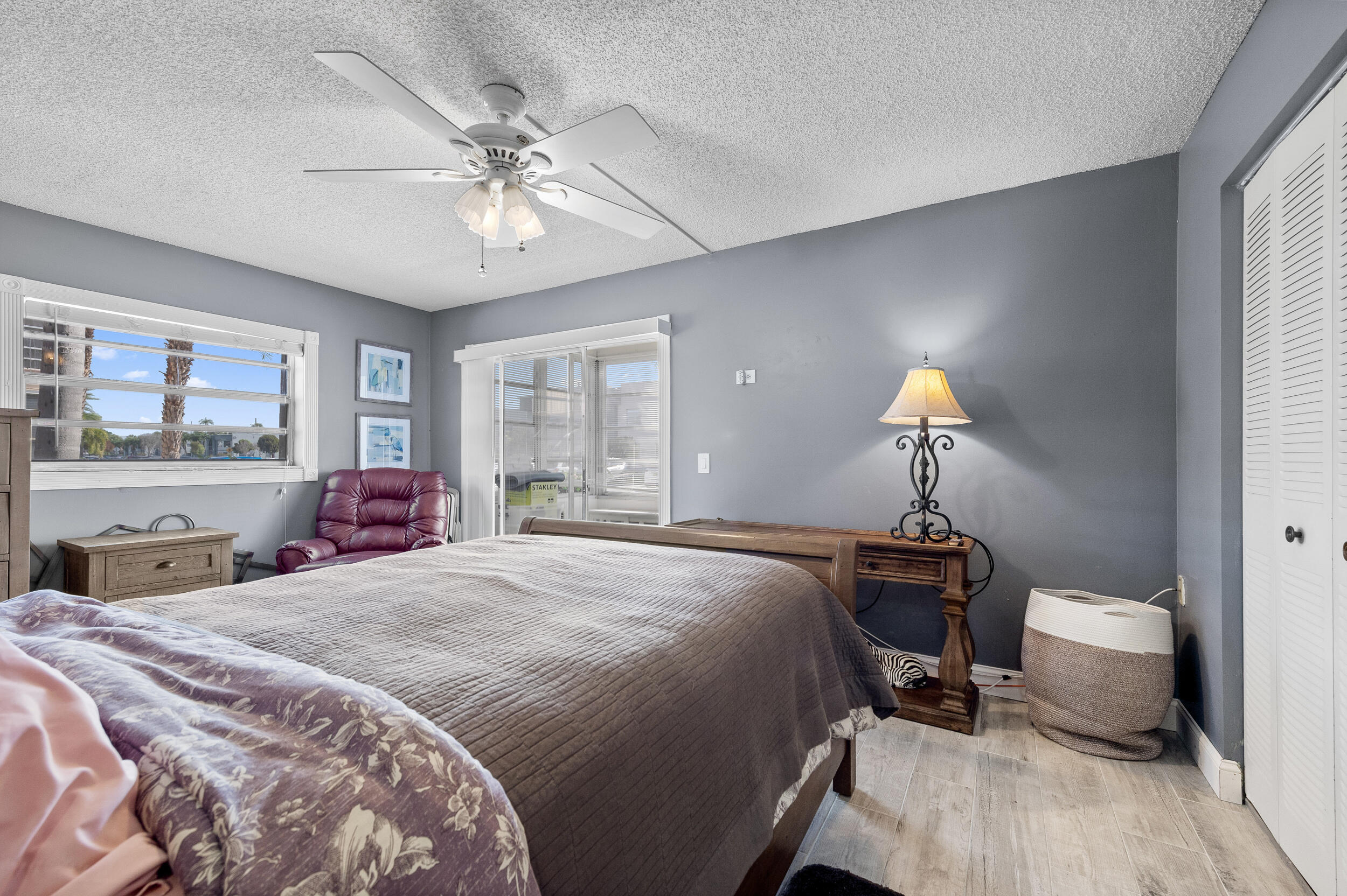 488 Burgundy P Delray Beach, FL 33484 - Photo 15 of 33 a bedroom with a bed and a chandelier