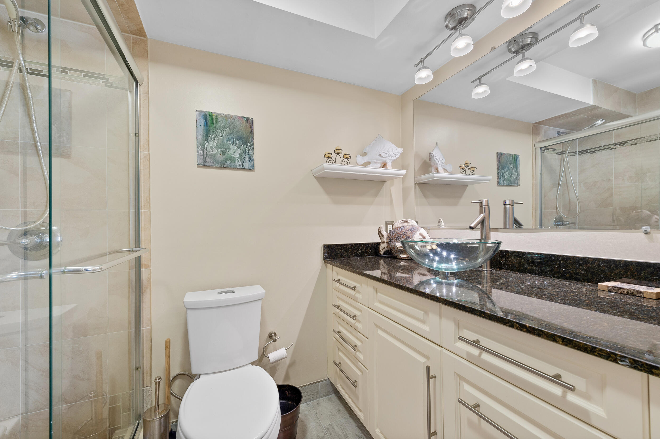 488 Burgundy P Delray Beach, FL 33484 - Photo 16 of 33 a bathroom with a toilet a sink and mirror