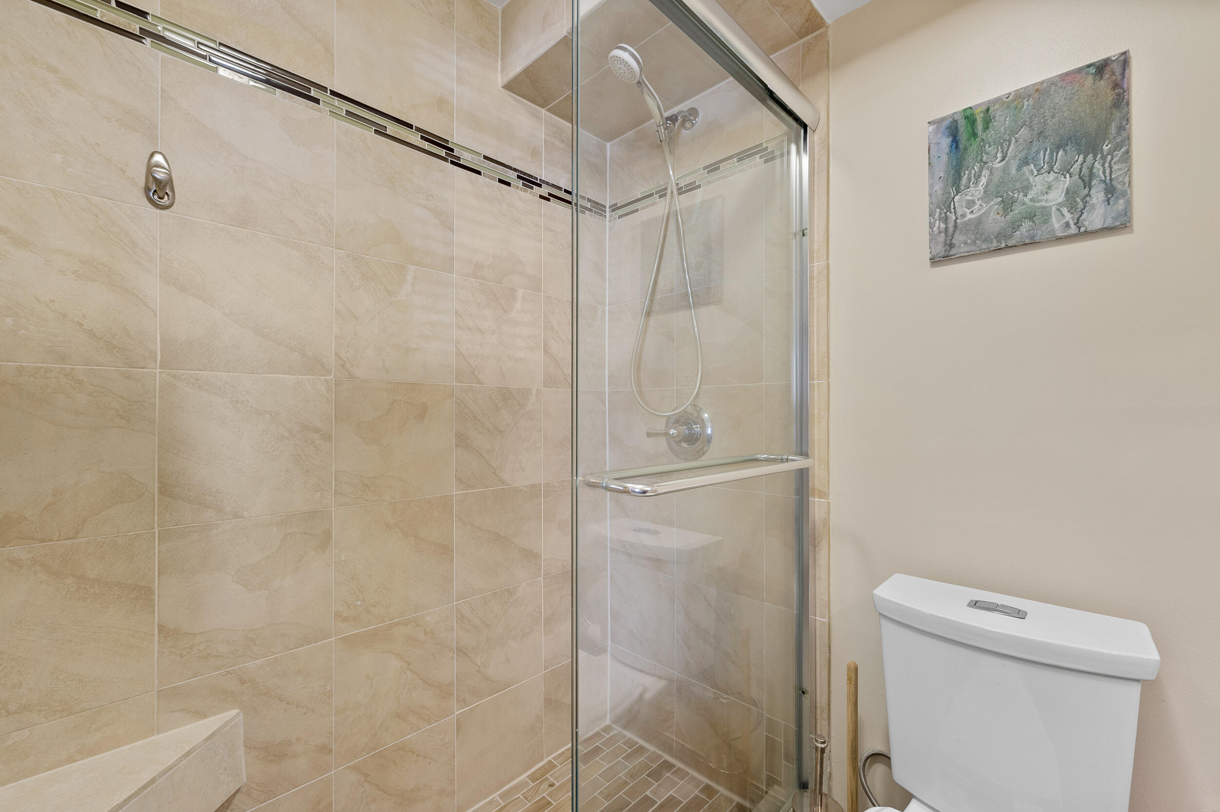 488 Burgundy P Delray Beach, FL 33484 - Photo 17 of 33 a bathroom with a shower a toilet and a shower