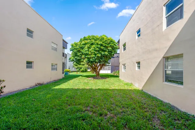 a view of a house with a yard and garage
