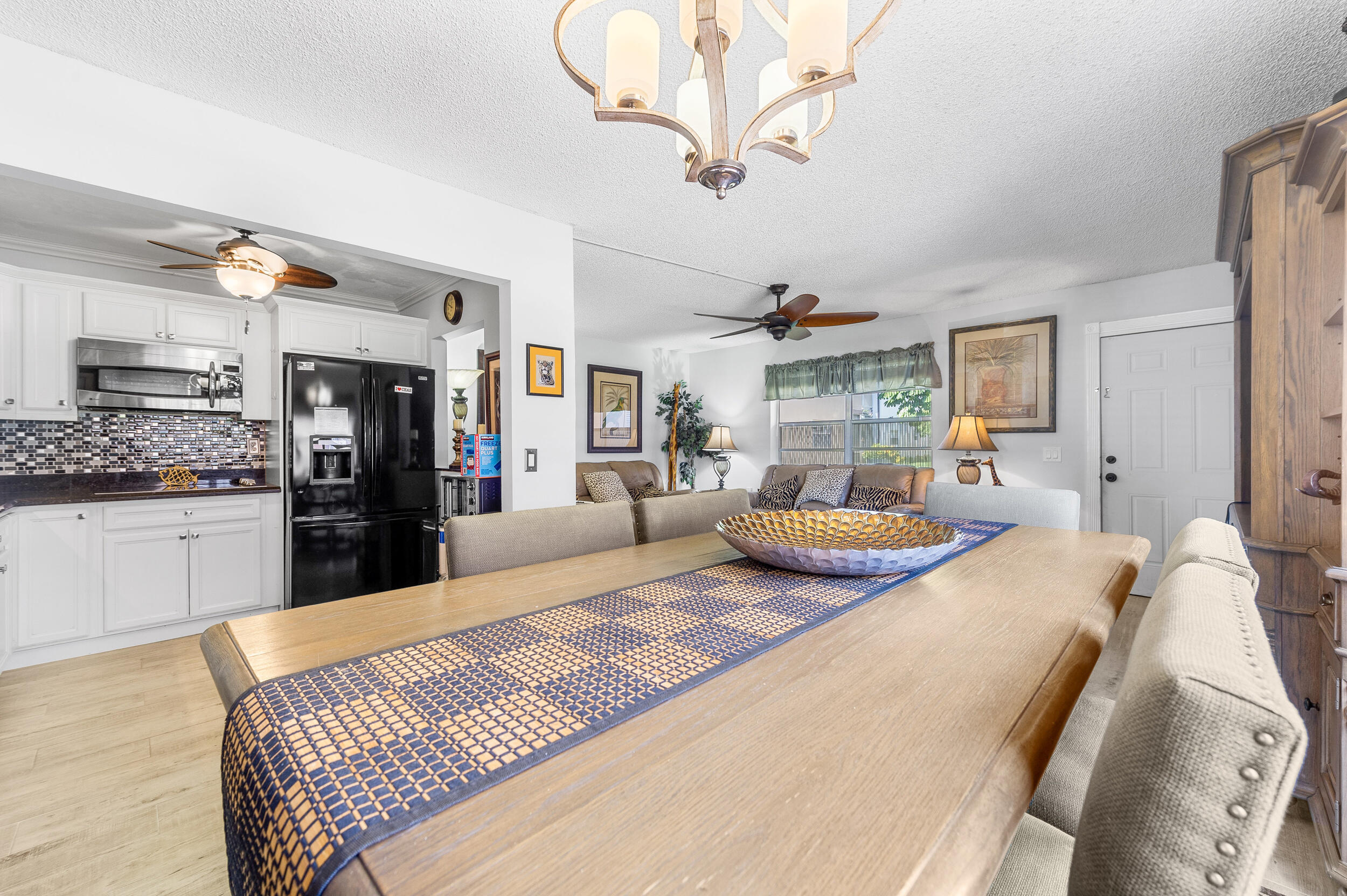 488 Burgundy P Delray Beach, FL 33484 - Photo 3 of 33 a bedroom with a large bed and a chandelier