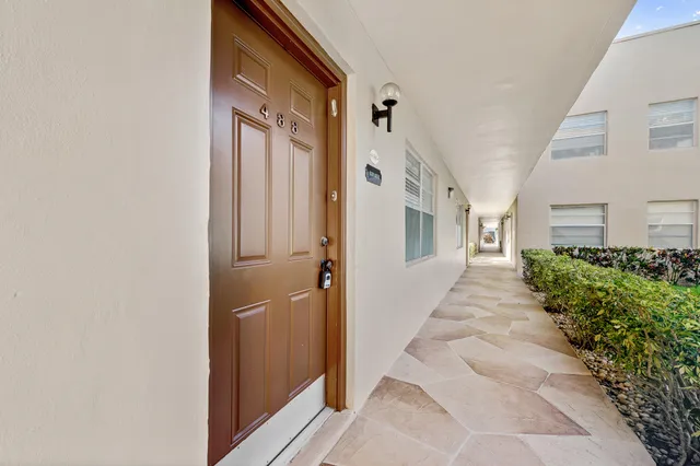 a living room with furniture a chandelier and a dining table