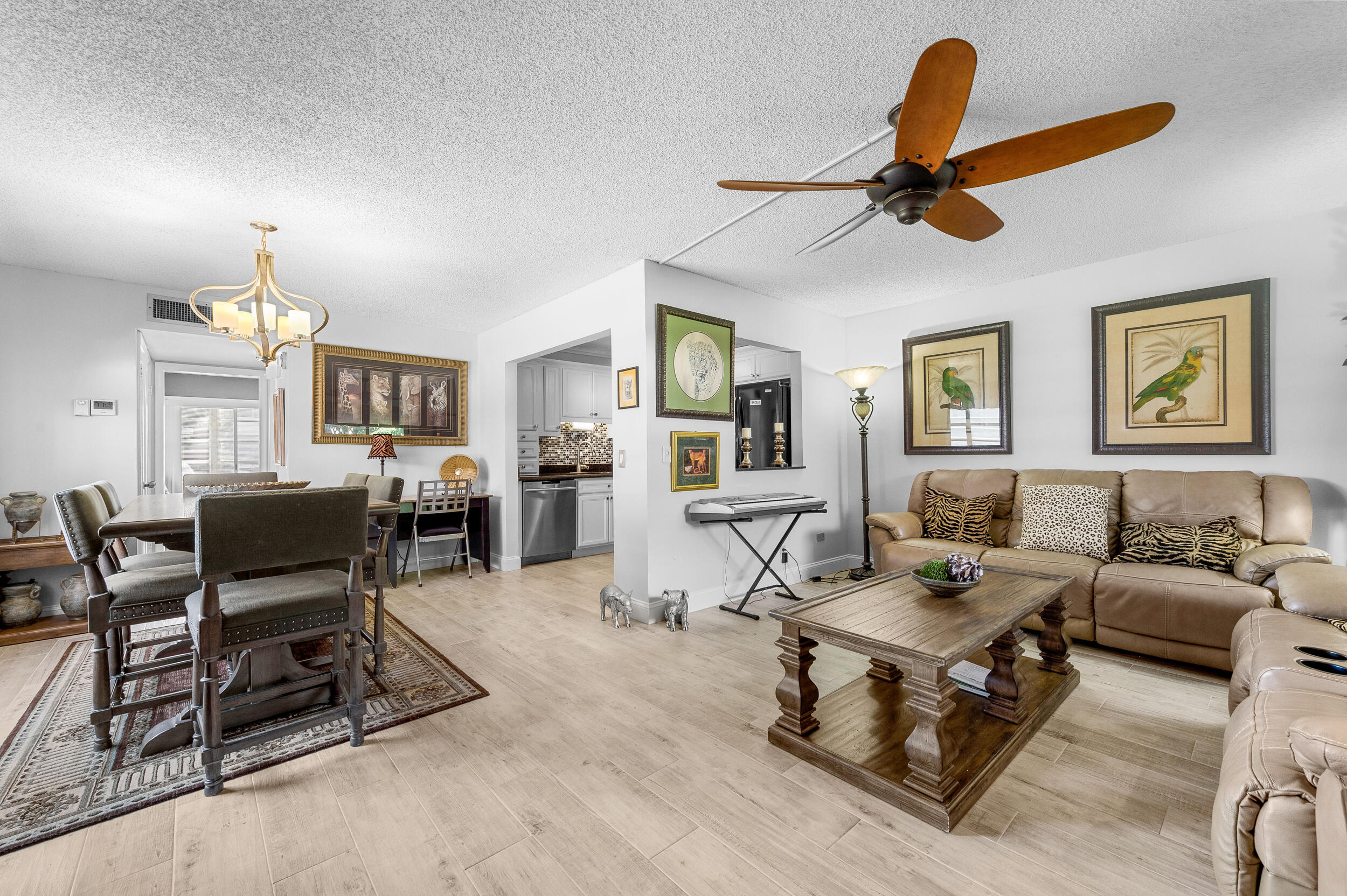 488 Burgundy P Delray Beach, FL 33484 - Photo 32 of 33 a living room with furniture a chandelier and a dining table