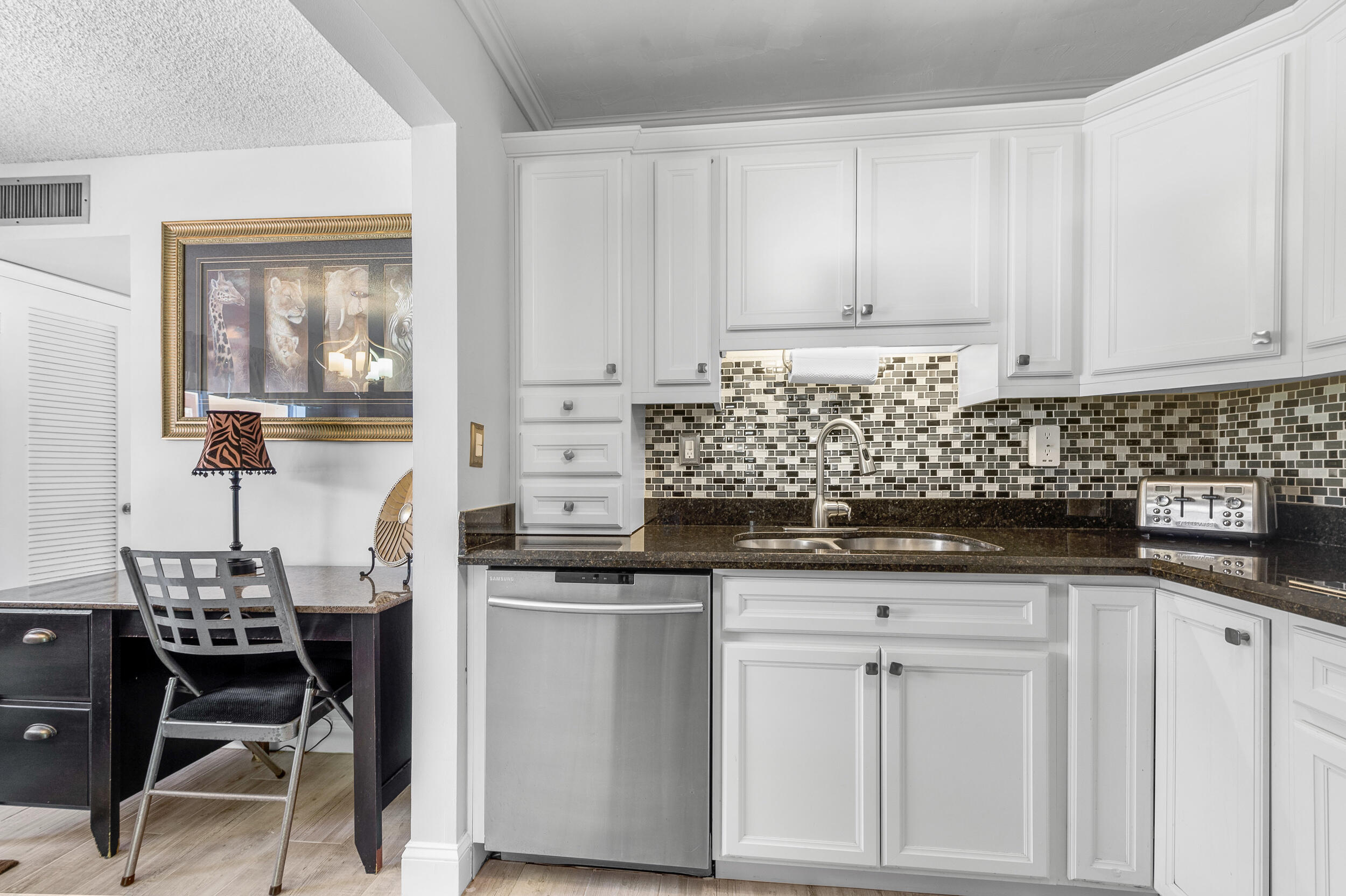488 Burgundy P Delray Beach, FL 33484 - Photo 4 of 33 a kitchen with stainless steel appliances granite countertop a sink and cabinets