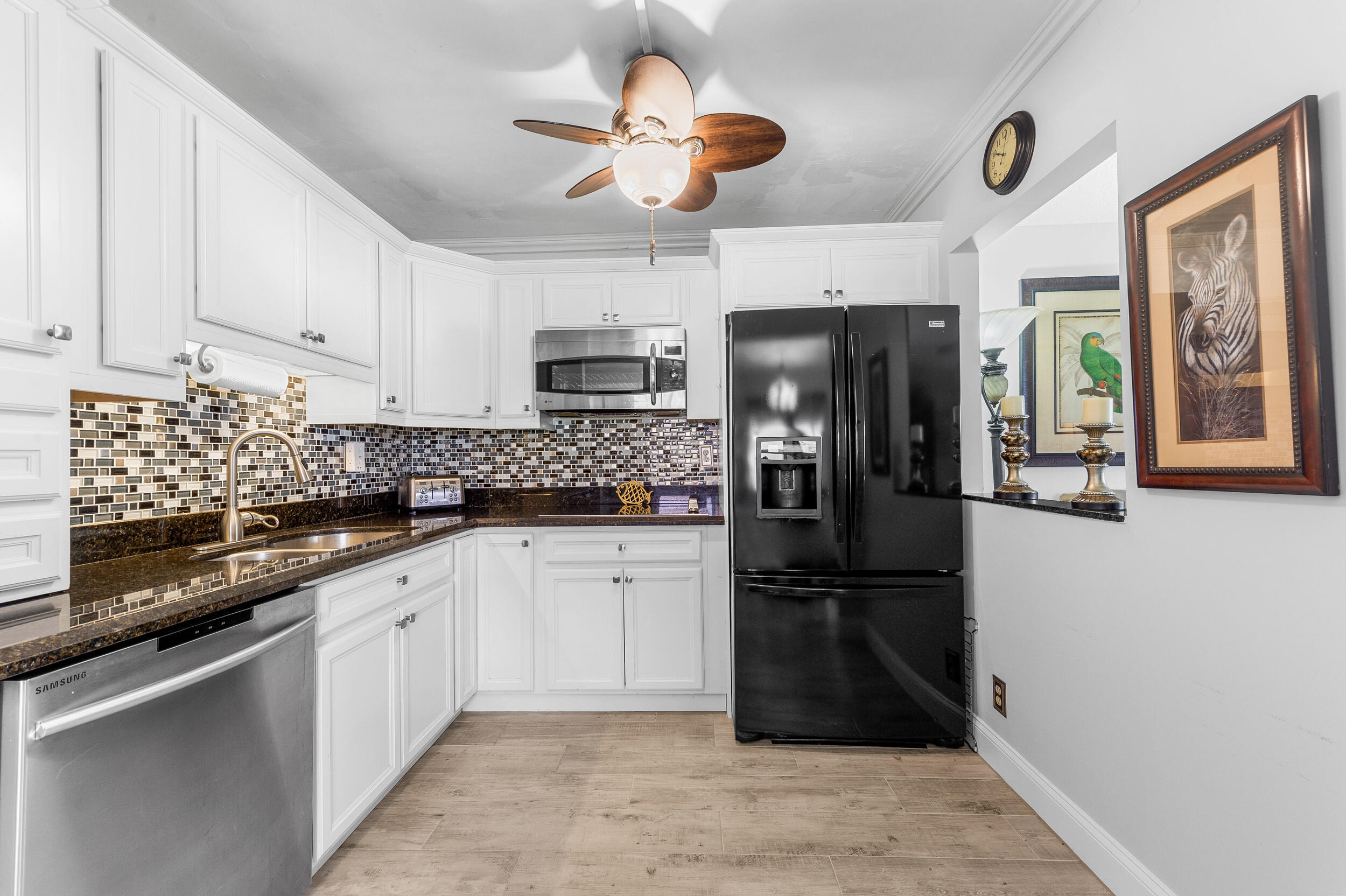 488 Burgundy P Delray Beach, FL 33484 - Photo 9 of 33 a kitchen with stainless steel appliances granite countertop a refrigerator a stove a sink and a microwave