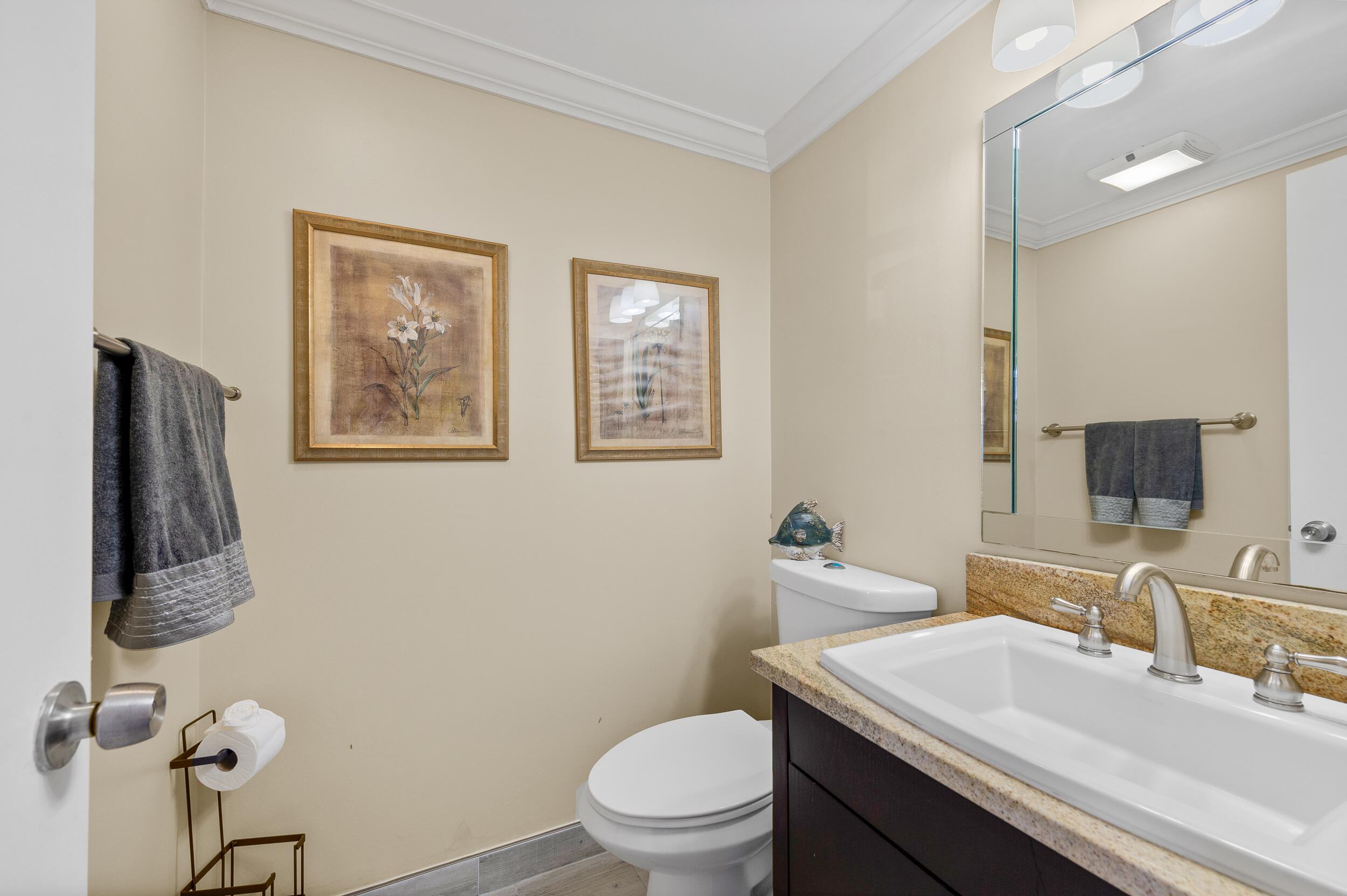 488 Burgundy P Delray Beach, FL 33484 - Photo 10 of 33 a bathroom with a toilet sink and mirror
