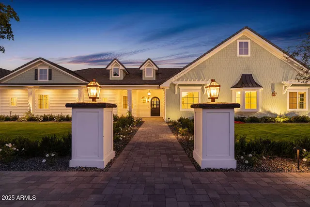 a front view of a house with yard and tree s