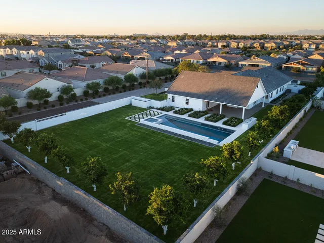 an aerial view of house with yard swimming pool and outdoor seating