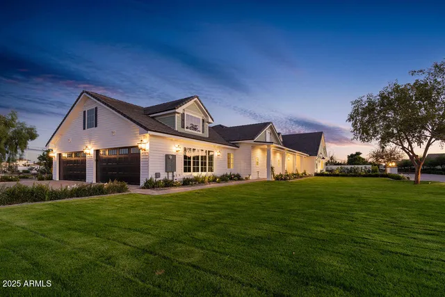 a front view of a house with a yard and trees