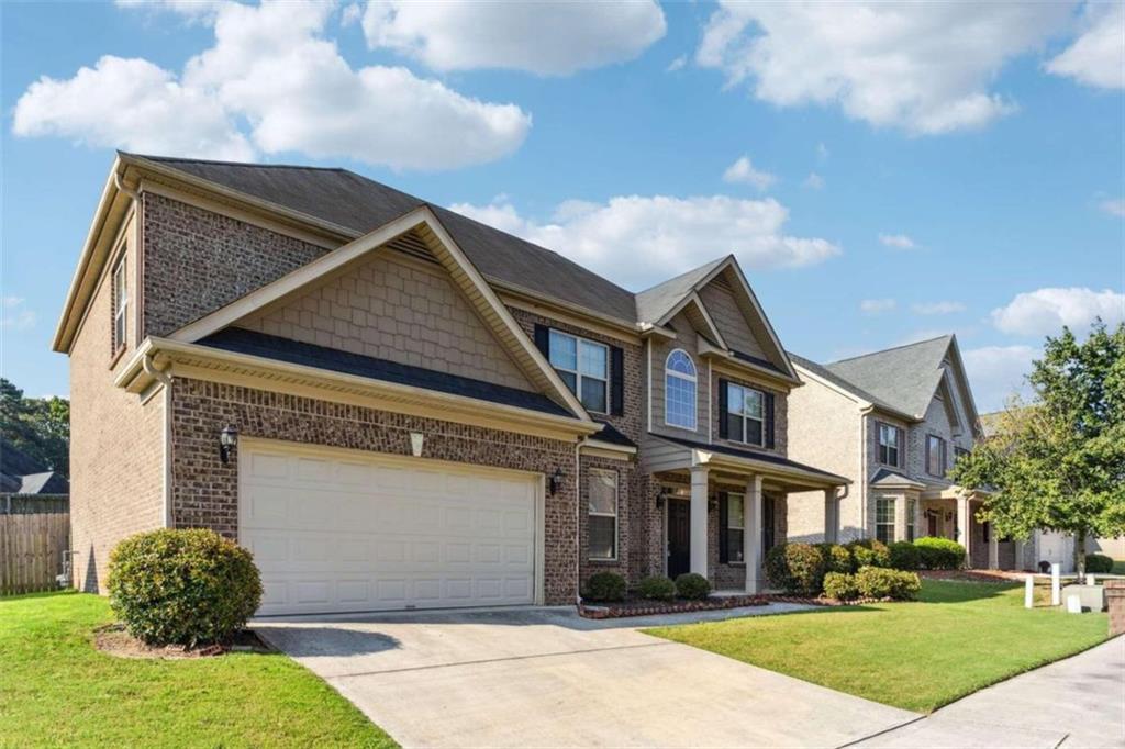 651 Arbor Ridge Loganville, GA 30052 - Photo 1 of 1 a front view of a house with garden