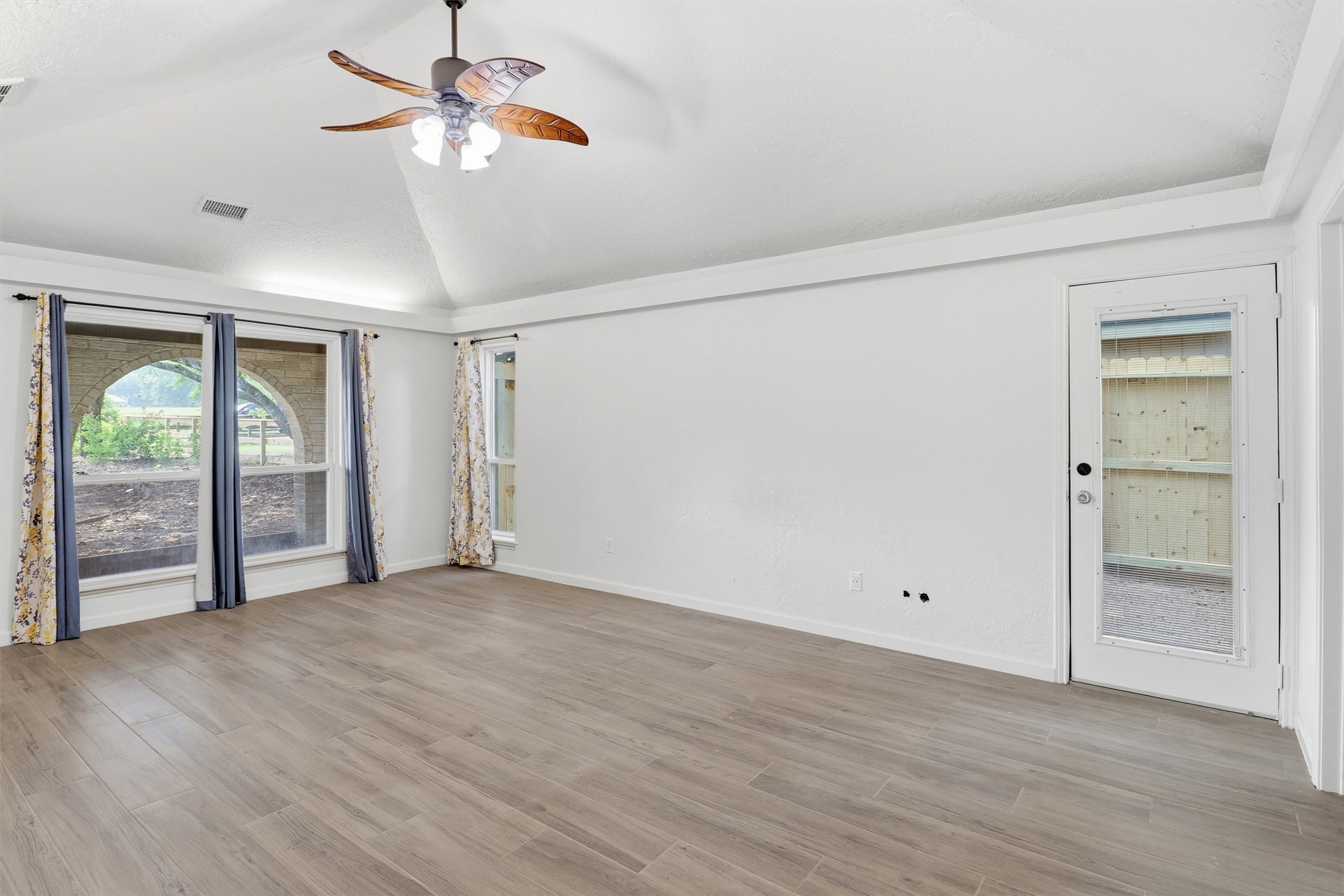 22923 Tomball Cemetery Road Tomball, TX 77377 - Photo 19 of 50 This spacious primary bedroom has ample room for all your furniture. The side door opens to a private space to enjoy coffee in the mornings.