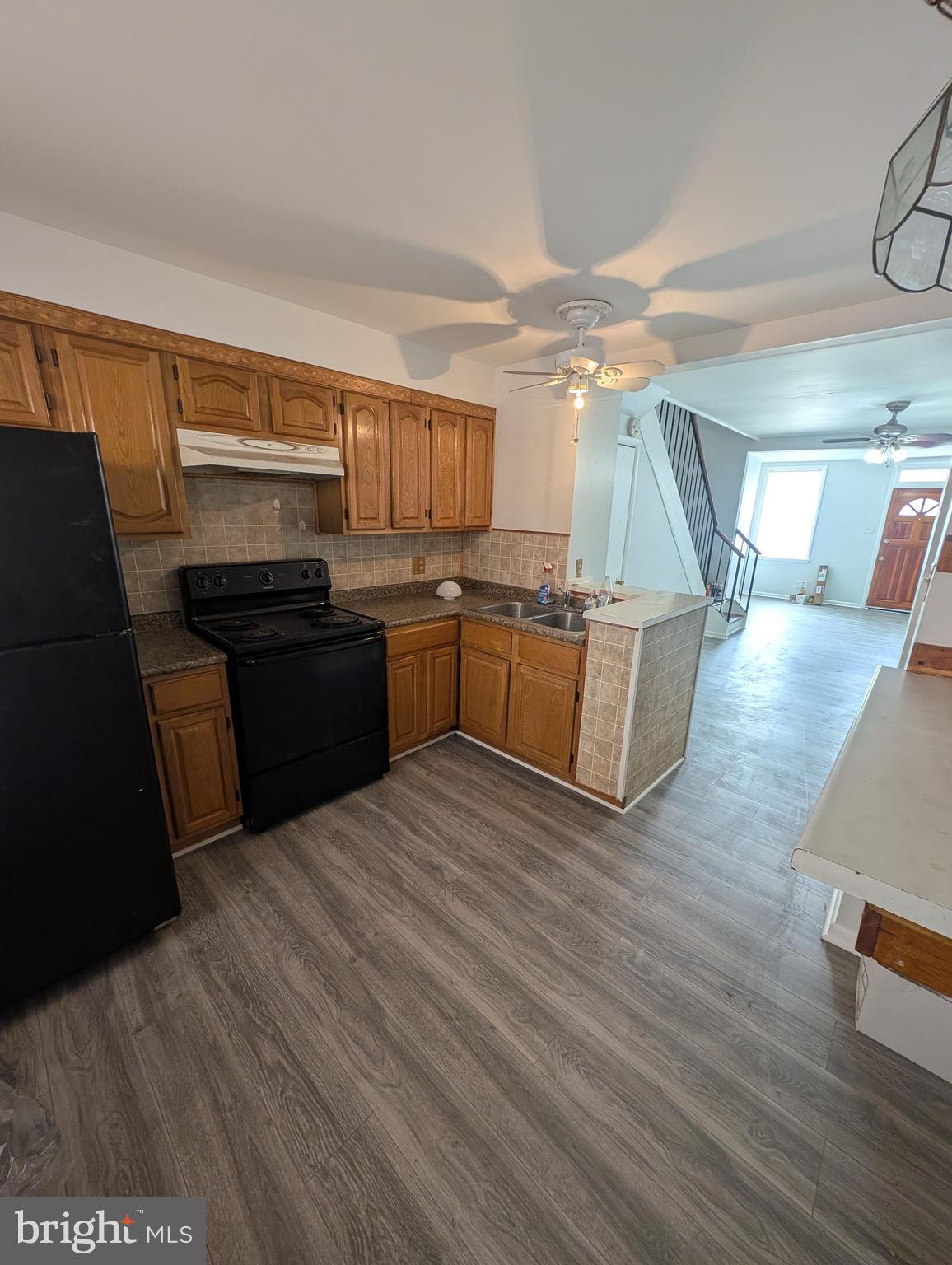 837 North Central Avenue Baltimore, MD 21202 - Photo 17 of 25 a kitchen with granite countertop a stove top oven and cabinets