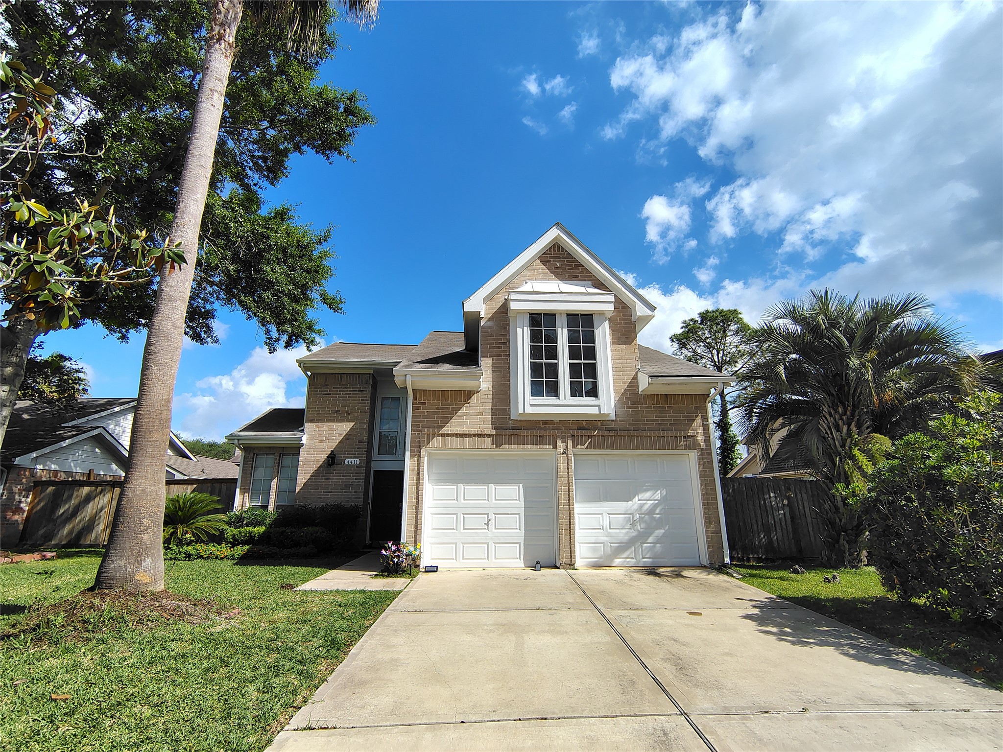 4411 Waterfall Way Sugar Land, TX 77479 - Photo 1 of 36 a front view of a house with a yard and garage