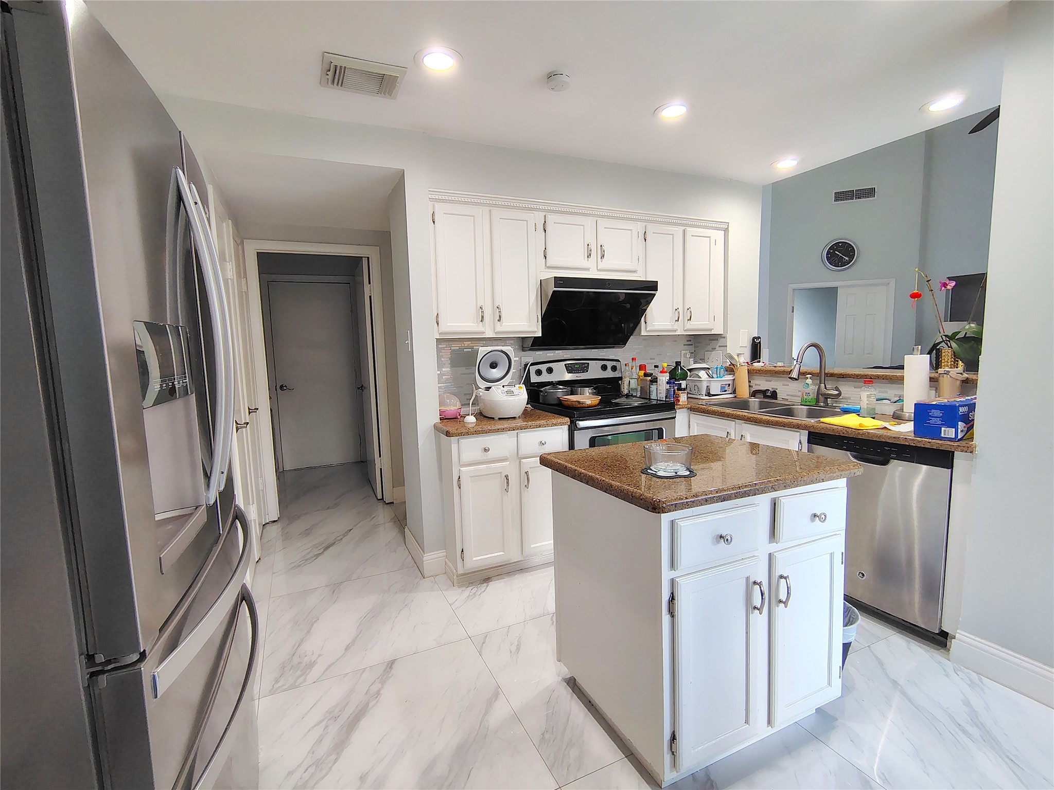 4411 Waterfall Way Sugar Land, TX 77479 - Photo 11 of 36 a kitchen that has a lot of cabinets a sink and a refrigerator