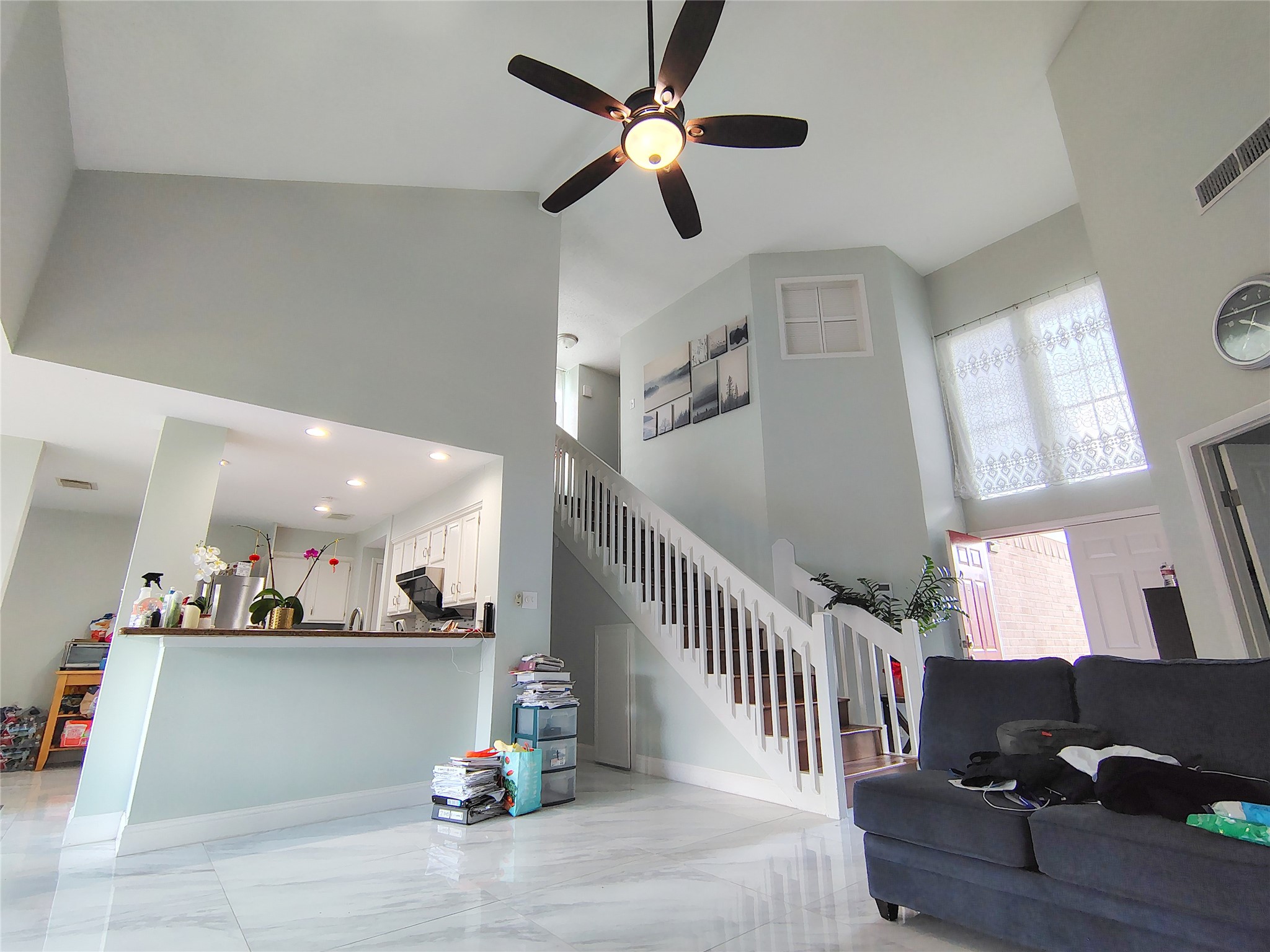4411 Waterfall Way Sugar Land, TX 77479 - Photo 19 of 36 a view of living room and kitchen with furniture a ceiling fan and a fireplace