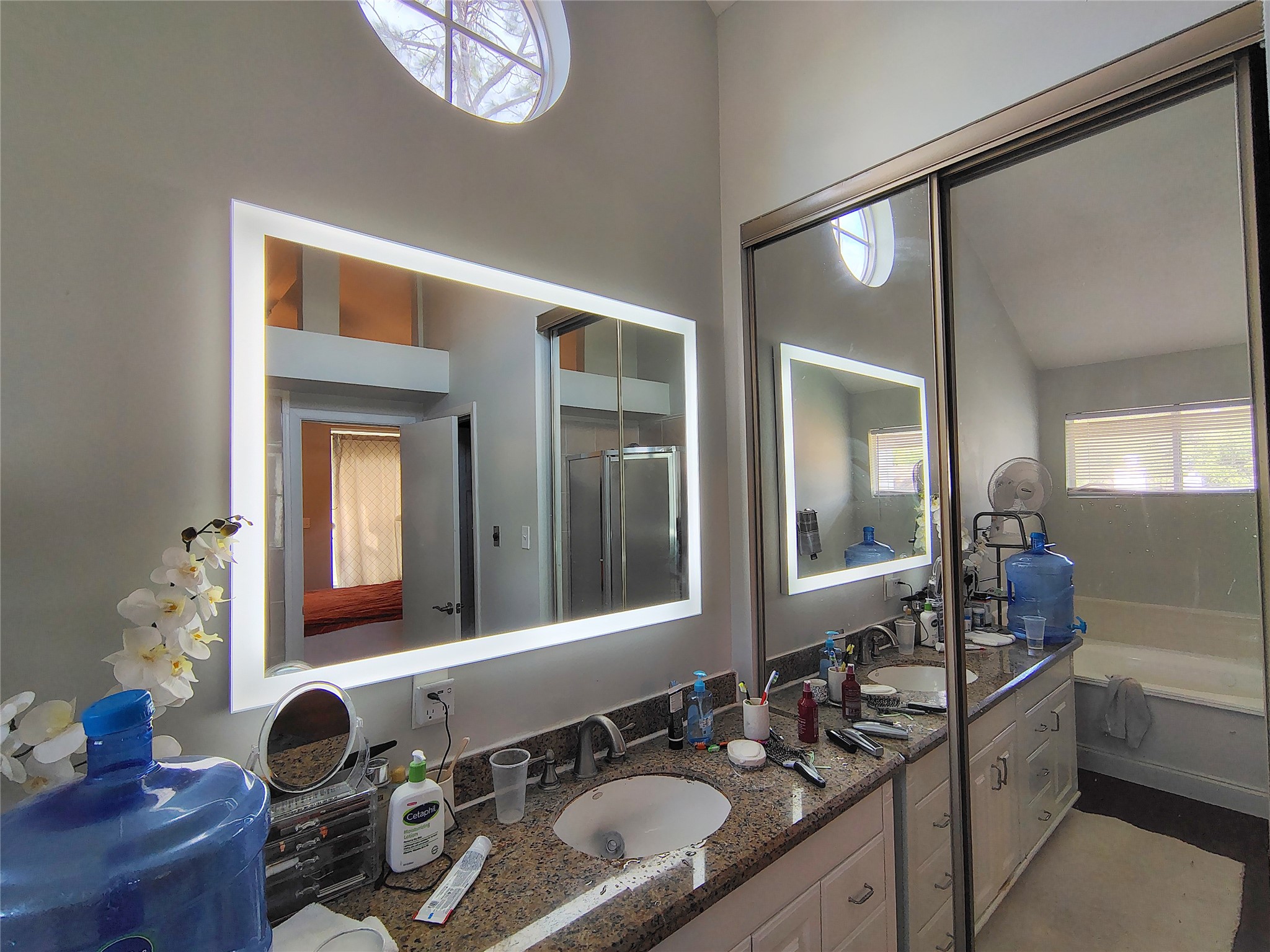 4411 Waterfall Way Sugar Land, TX 77479 - Photo 25 of 36 a bathroom with a granite countertop sink a large mirror and a bathtub