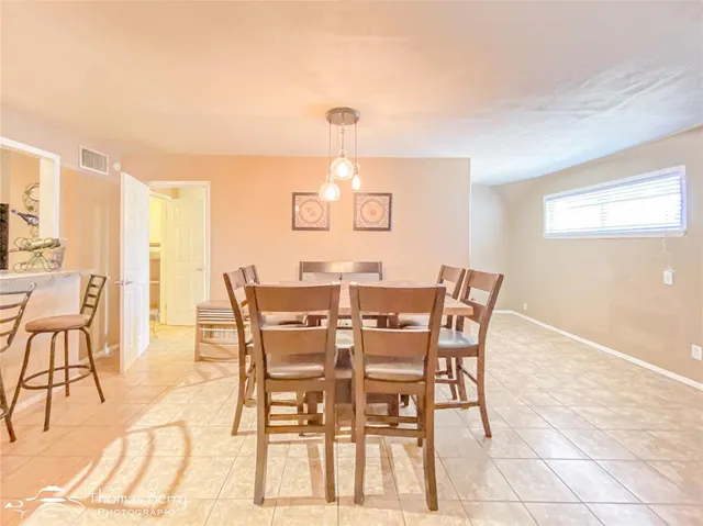 a view of a dining room with furniture and a potted plant