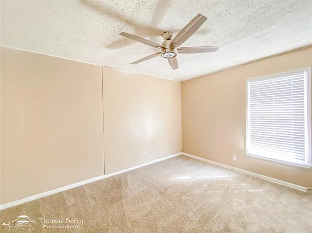 a view of a livingroom with a ceiling fan and window