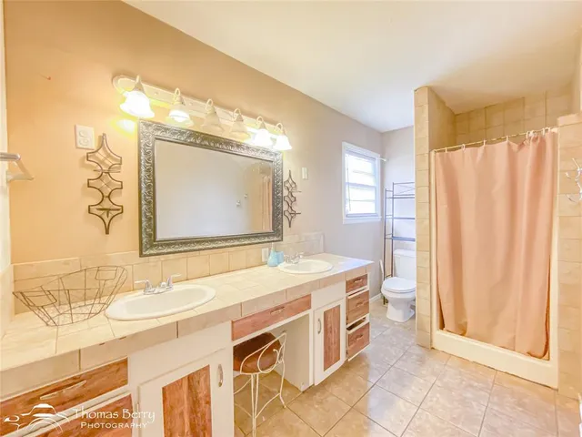 a spacious bathroom with a sink double vanity and a mirror