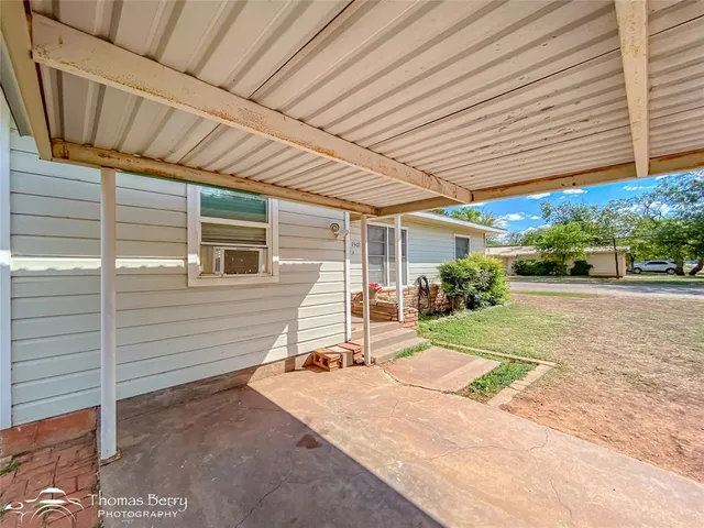 a view of backyard with a patio