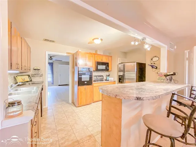 a large kitchen with a table and chairs