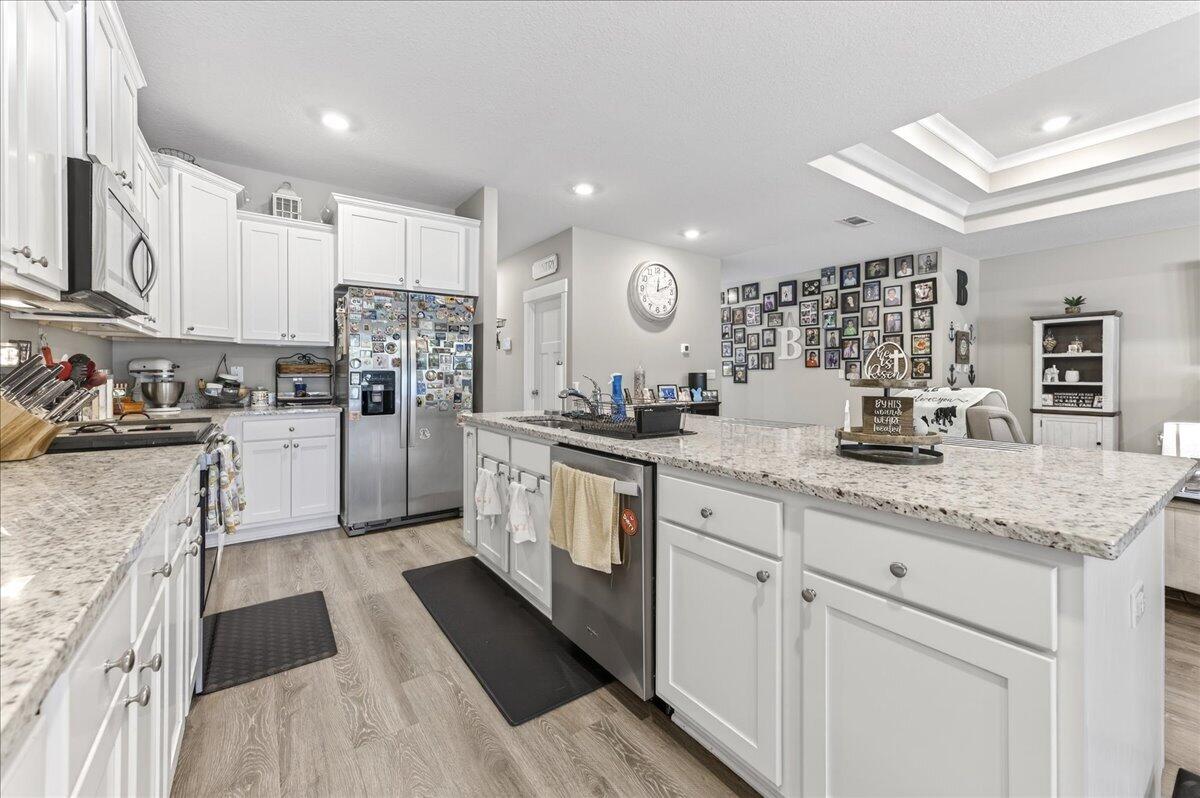 2455 Dakota Way Crestview, FL 32536 - Photo 20 of 81 a kitchen with white cabinets and stainless steel appliances