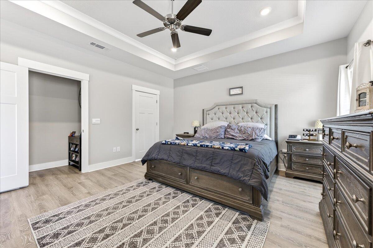 2455 Dakota Way Crestview, FL 32536 - Photo 31 of 81 a bedroom with a bed and a chandelier