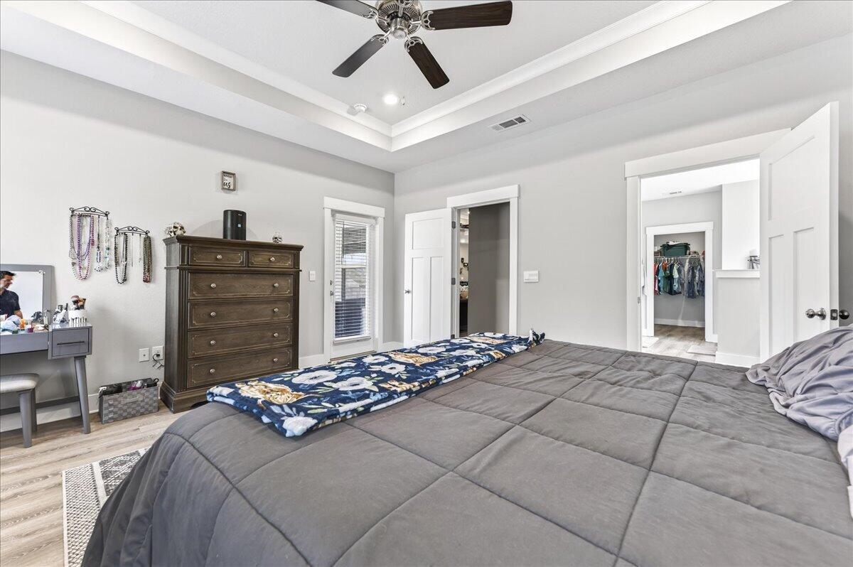 2455 Dakota Way Crestview, FL 32536 - Photo 32 of 81 a bedroom with a bed and a chandelier