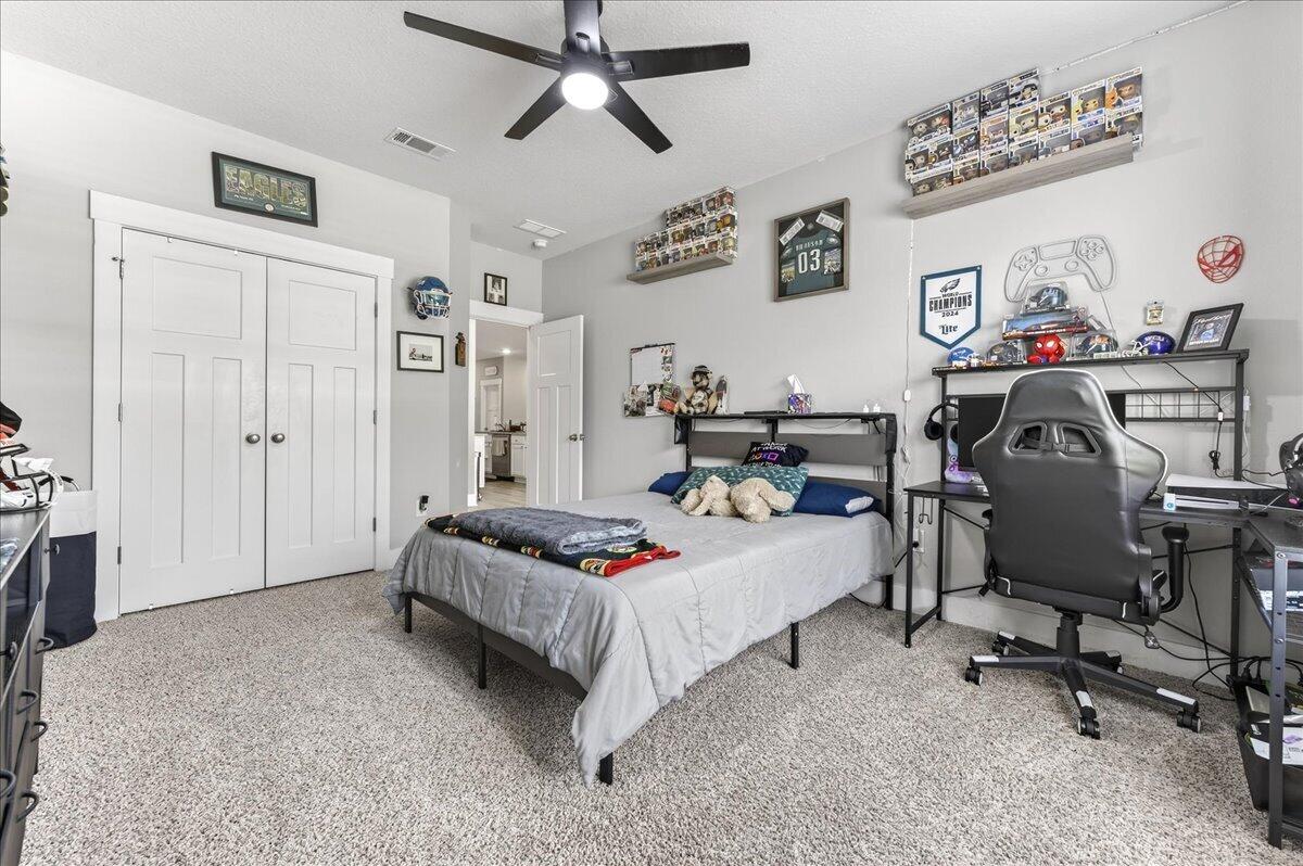2455 Dakota Way Crestview, FL 32536 - Photo 43 of 81 a bedroom that has a bed and a chair in it