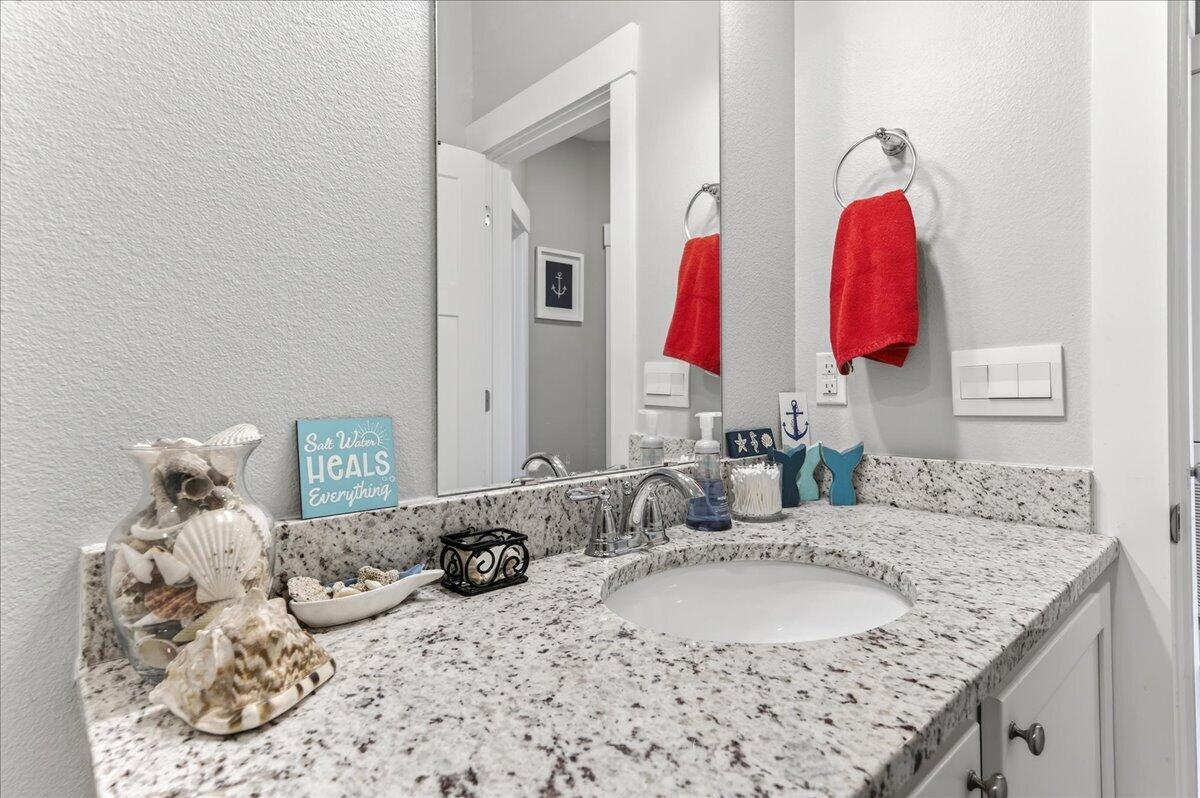 2455 Dakota Way Crestview, FL 32536 - Photo 54 of 81 a bathroom with a granite countertop sink and a mirror