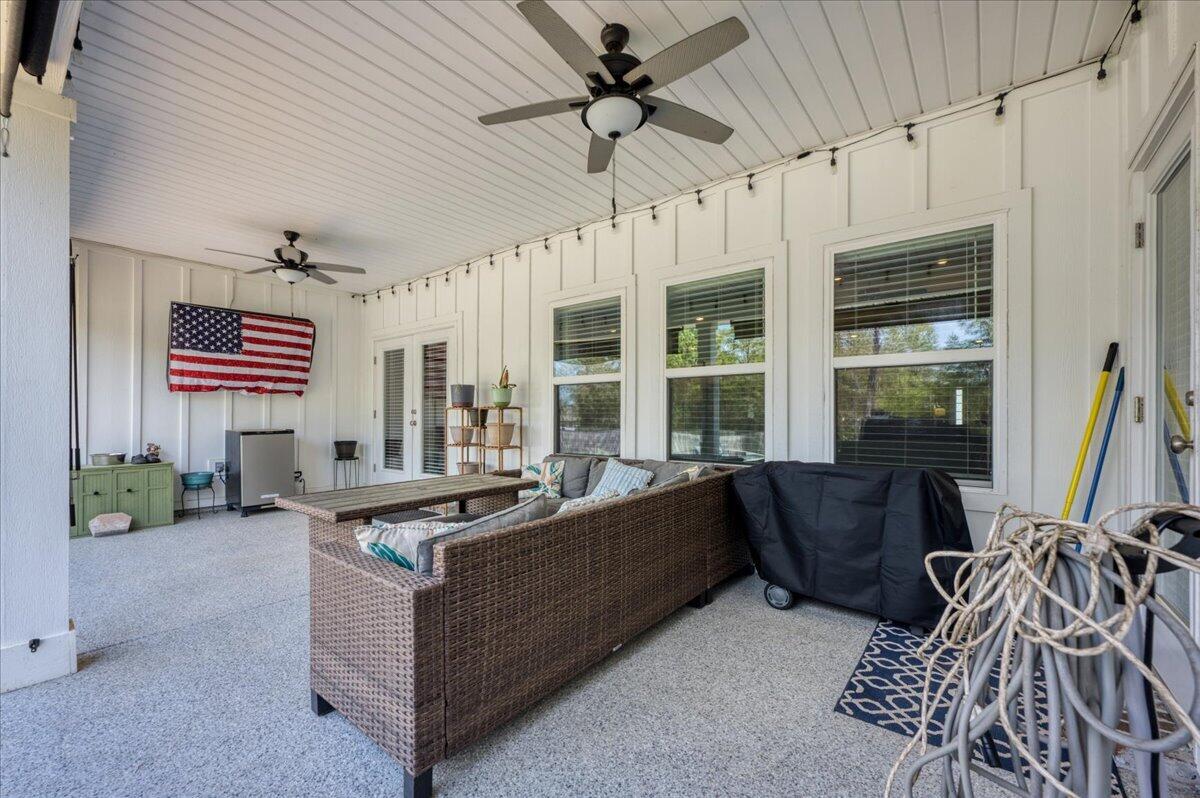2455 Dakota Way Crestview, FL 32536 - Photo 60 of 81 a living room with furniture a flat screen tv and a large window