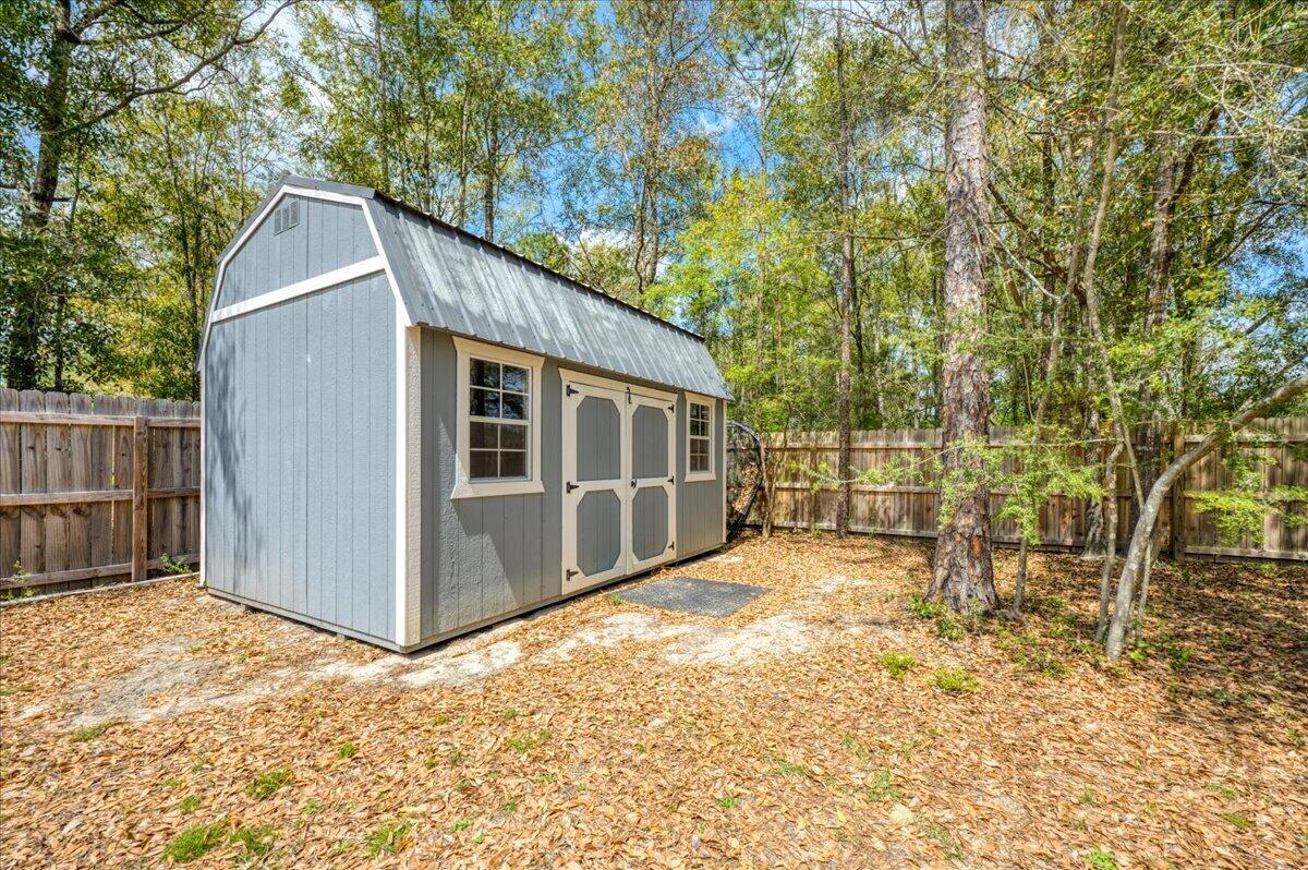2455 Dakota Way Crestview, FL 32536 - Photo 69 of 81 a view of backyard with large trees and wooden fence
