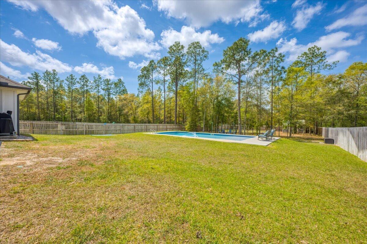 2455 Dakota Way Crestview, FL 32536 - Photo 75 of 81 a view of outdoor space with swimming pool and green space