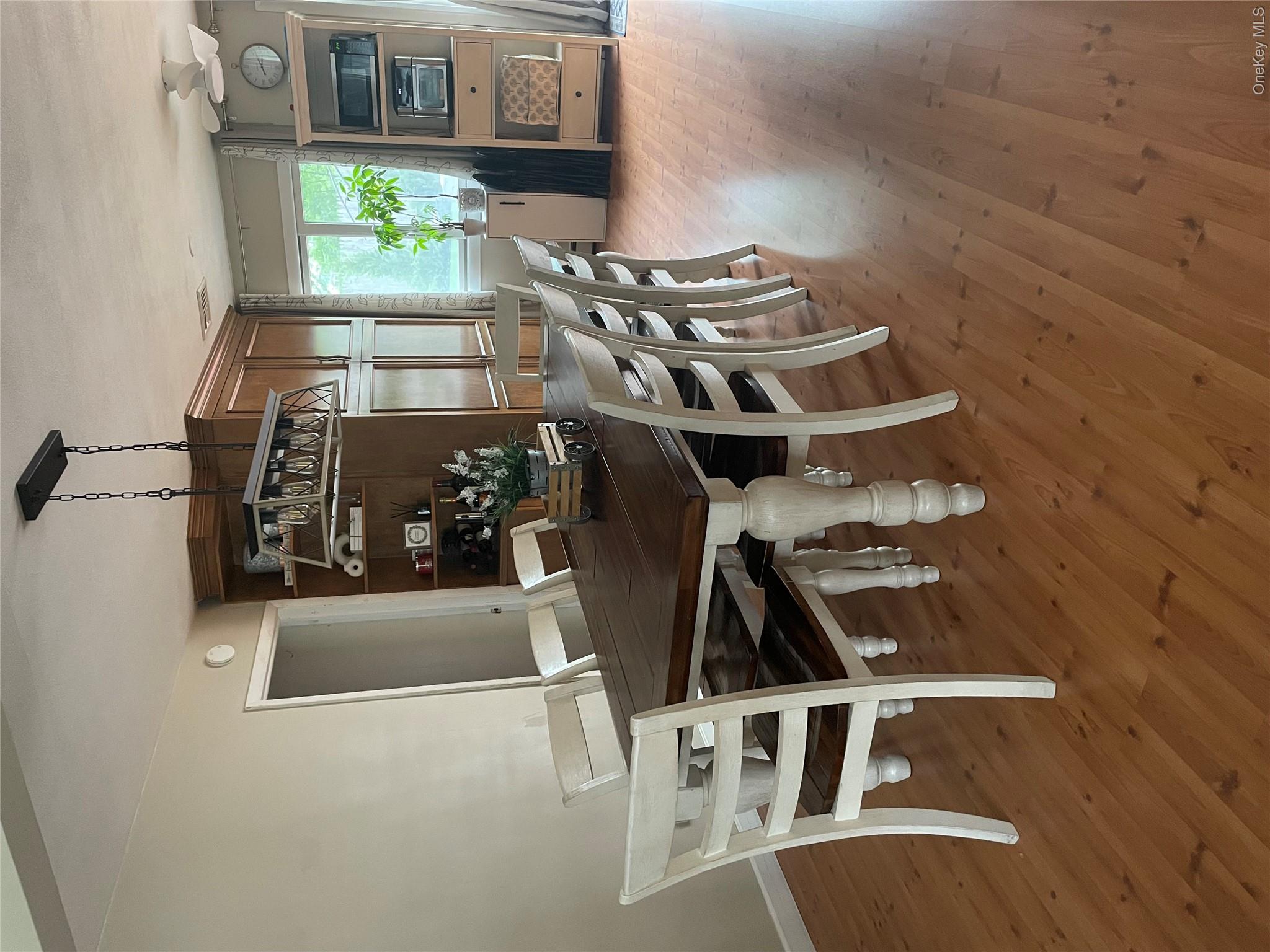 161 Hawkins Road Centereach, NY 11720 - Photo 2 of 16 a view of a dining room with furniture window and wooden floor
