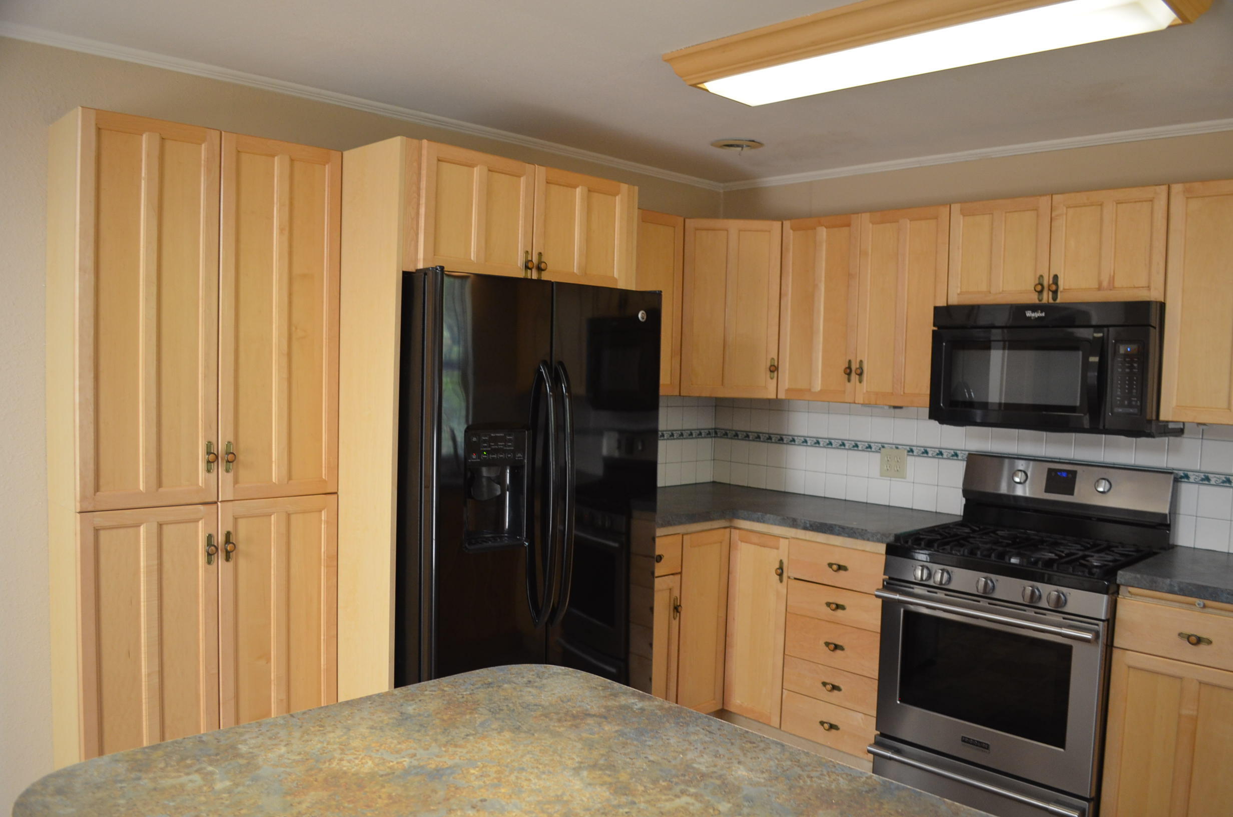 137008 Main Street Crescent, OR 97733 - Photo 9 of 50 a kitchen with stainless steel appliances granite countertop a refrigerator stove and cabinets