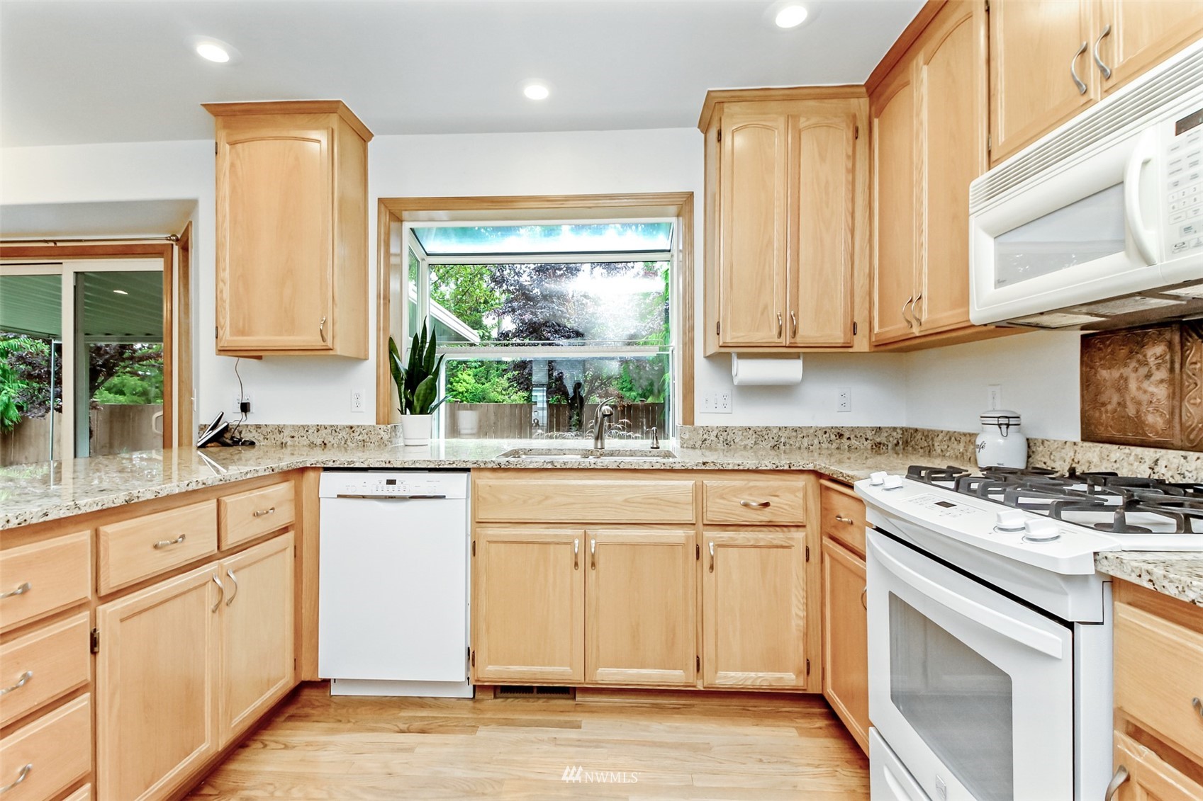 25815 176th Place Southeast Covington, WA 98042 - Photo 16 of 36 a kitchen with granite countertop white cabinets and white appliances