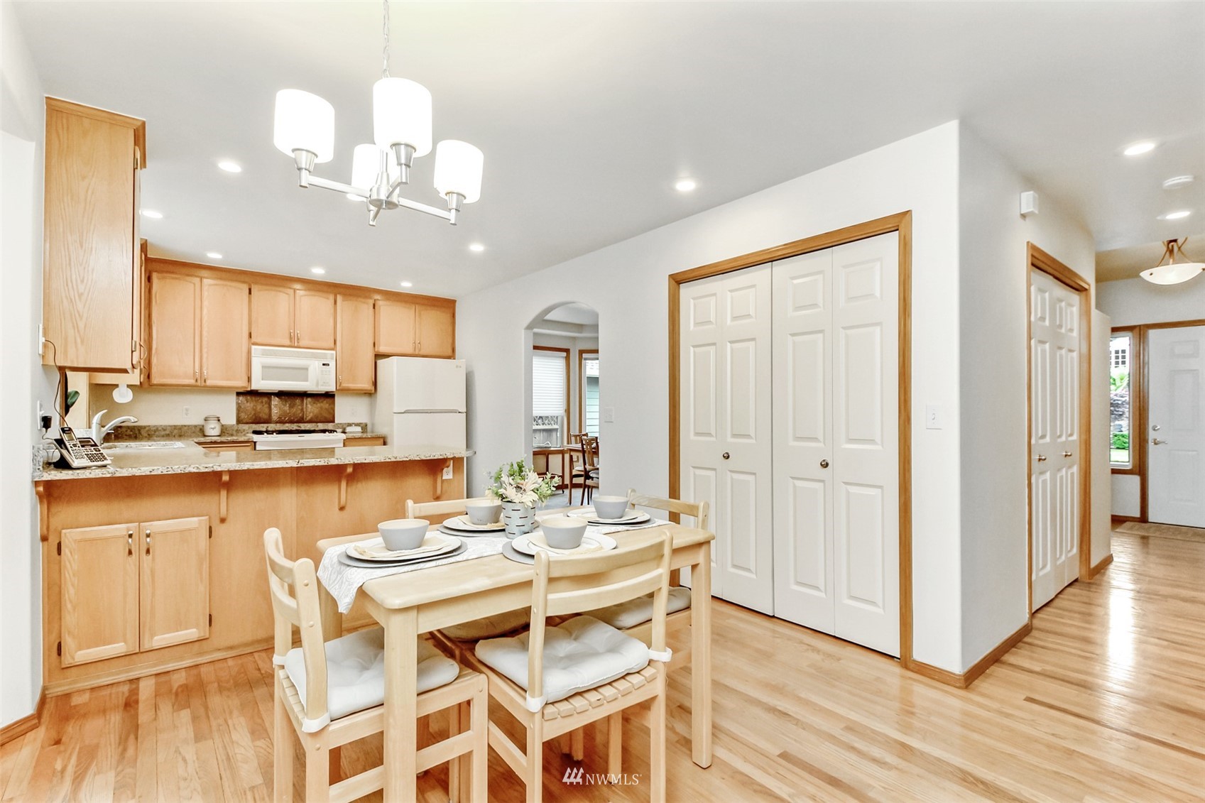 25815 176th Place Southeast Covington, WA 98042 - Photo 17 of 36 a dining room with granite countertop wooden floor and chandelier