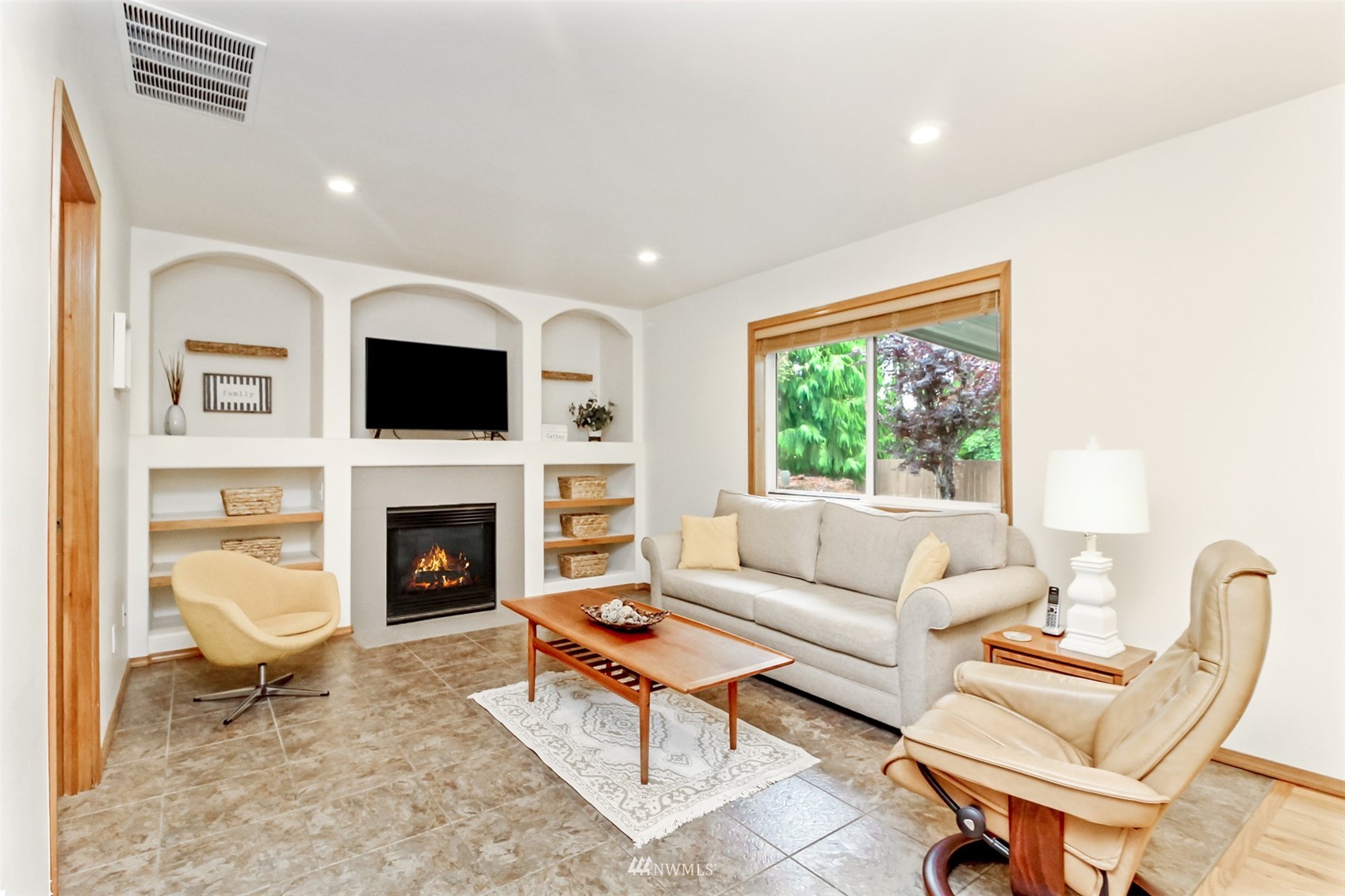 25815 176th Place Southeast Covington, WA 98042 - Photo 20 of 36 a living room with furniture a fireplace and a flat screen tv