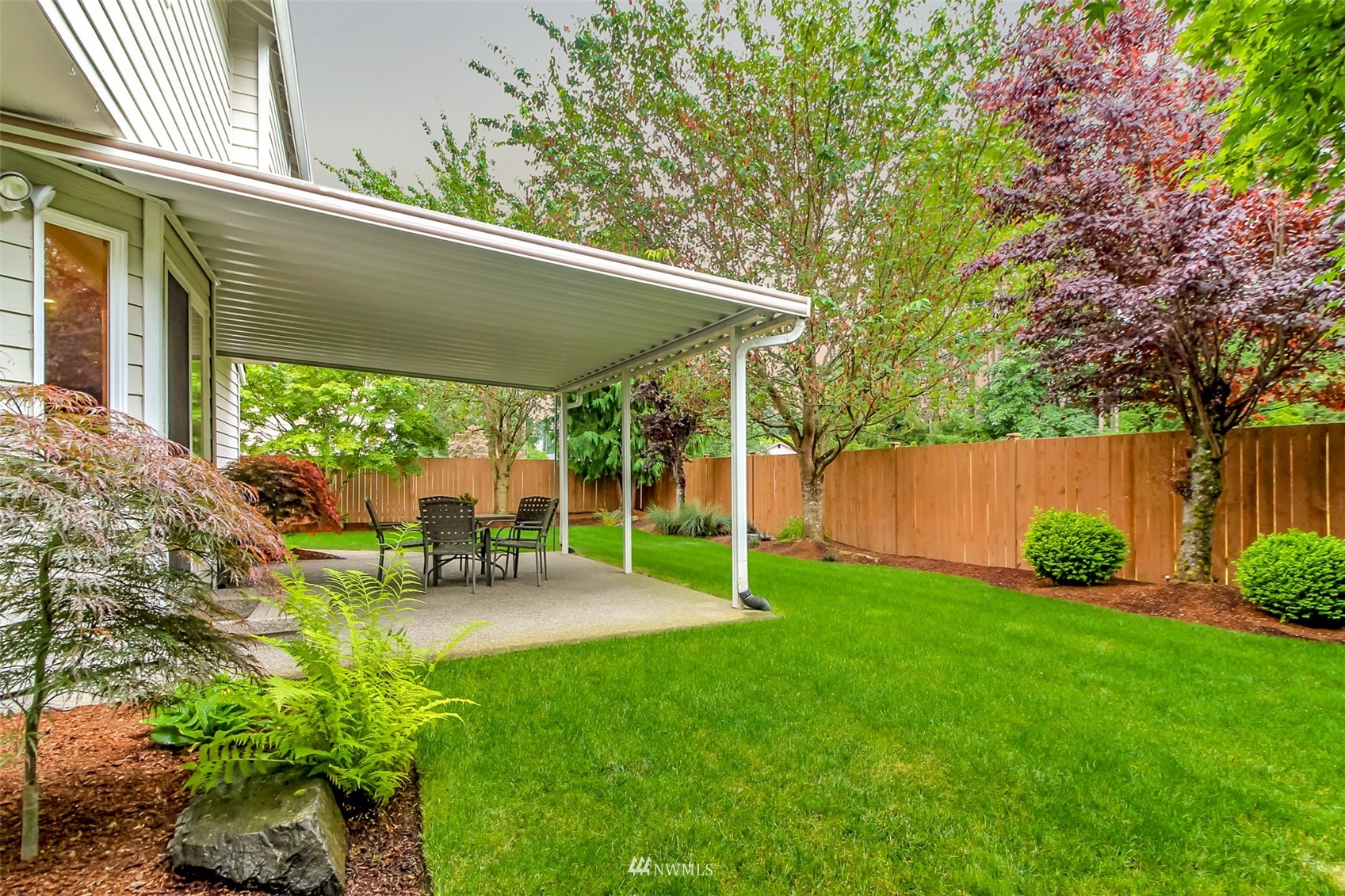 25815 176th Place Southeast Covington, WA 98042 - Photo 31 of 36 a view of a patio with table and chairs under an umbrella