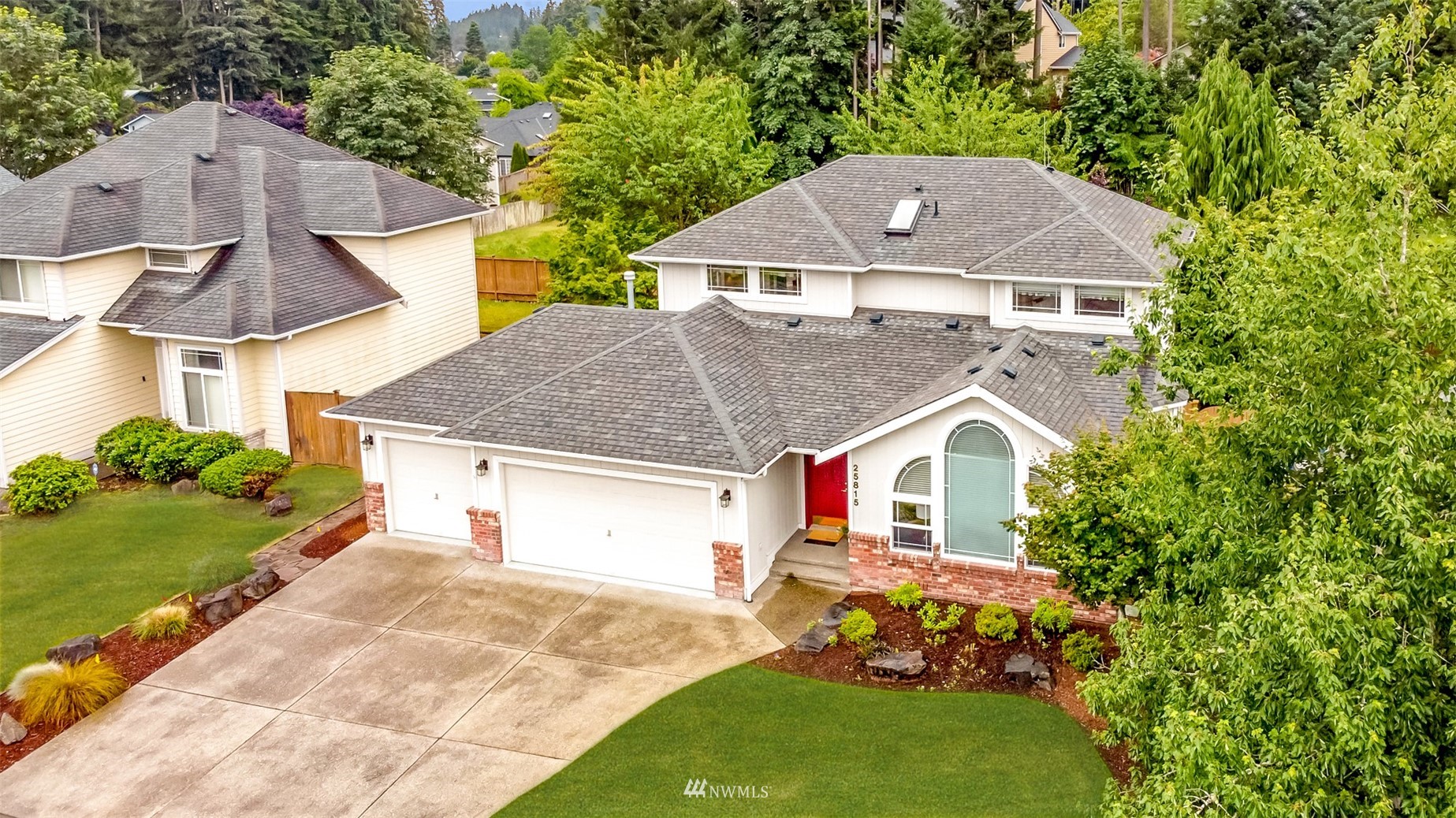 25815 176th Place Southeast Covington, WA 98042 - Photo 6 of 36 a aerial view of a house next to a yard with plants and a lawn chairs