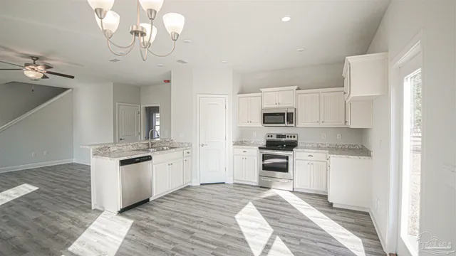 a kitchen with stainless steel appliances granite countertop a stove and refrigerator