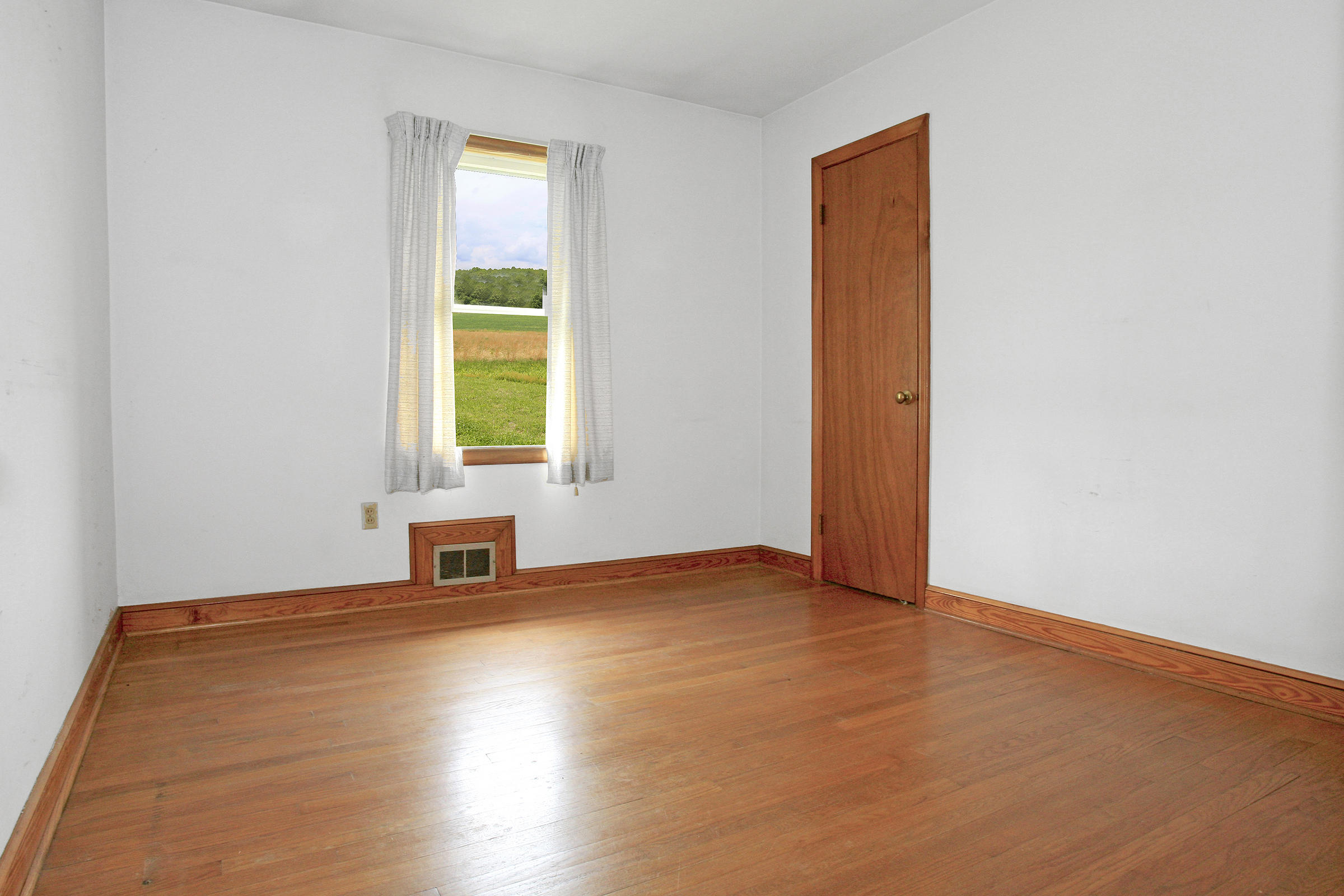 1058 Silverleaf Road Southeast Floyd, VA 24091 - Photo 11 of 55 a view of an empty room with wooden floor and a window